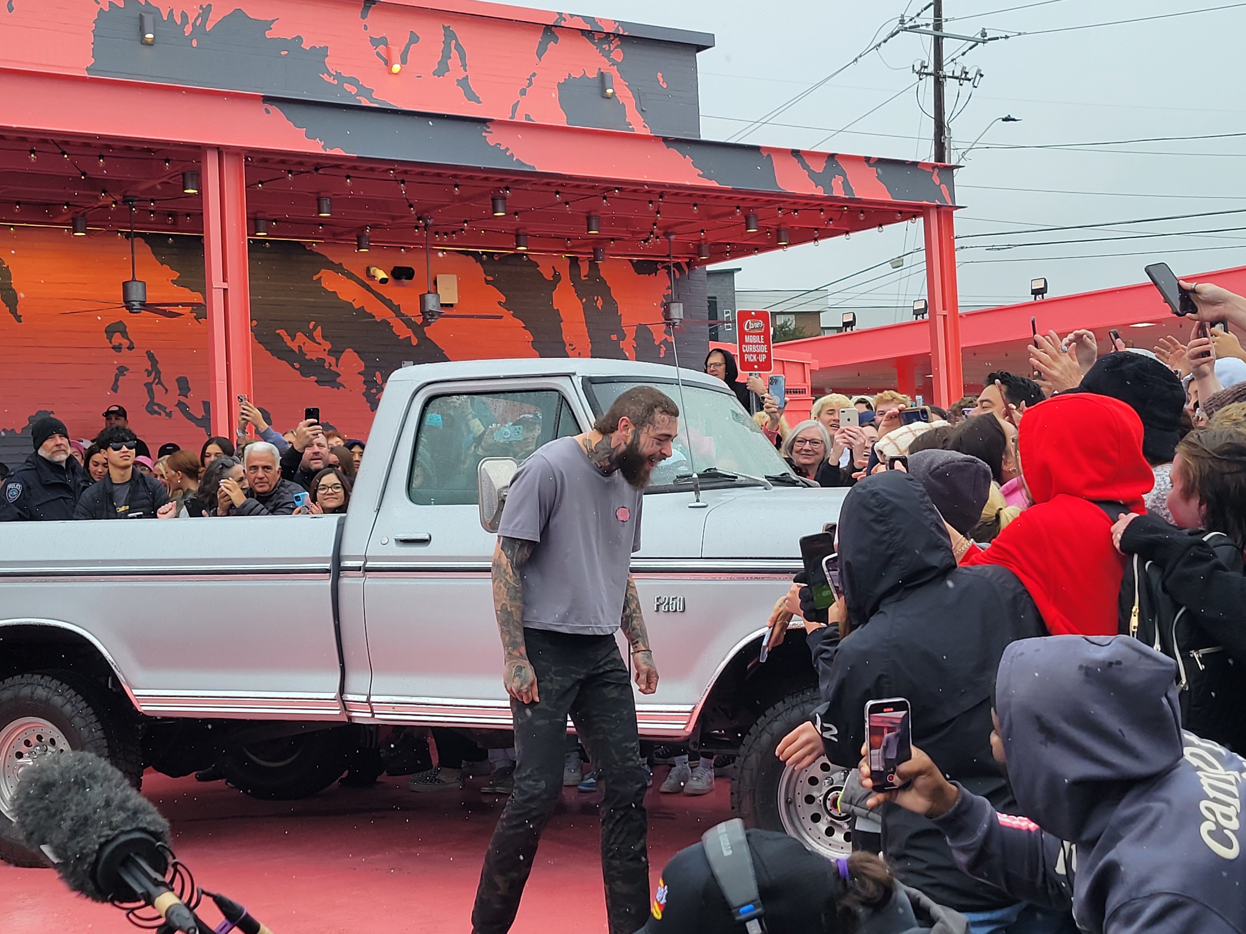 Post Malone cuts ribbon on custom-designed Raising Cane's restaurant