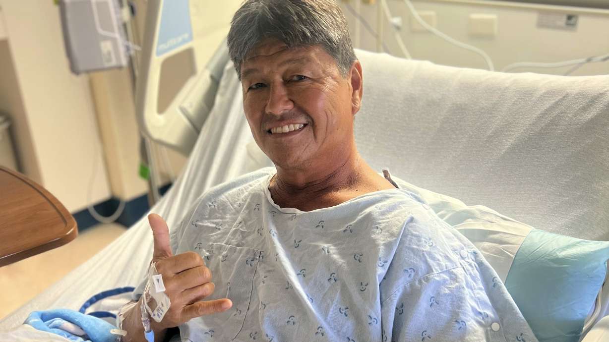 Mike Morita poses for a photo from his hospital bed, Wednesday, April 10, 2023, in Honolulu. Morita credits a faith in God for surviving an Easter Sunday shark attack and for remaining at peace despite losing his right foot.