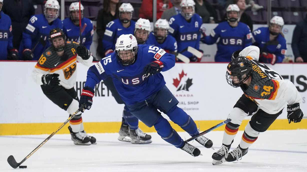 Germany forward Celina Haider (34) trips up USA defender Savannah Harmon (15) during the second period of a quarterfinal match at the Women's World Hockey Championships in Brampton, Ontario, Thursday, April 13, 2023.
