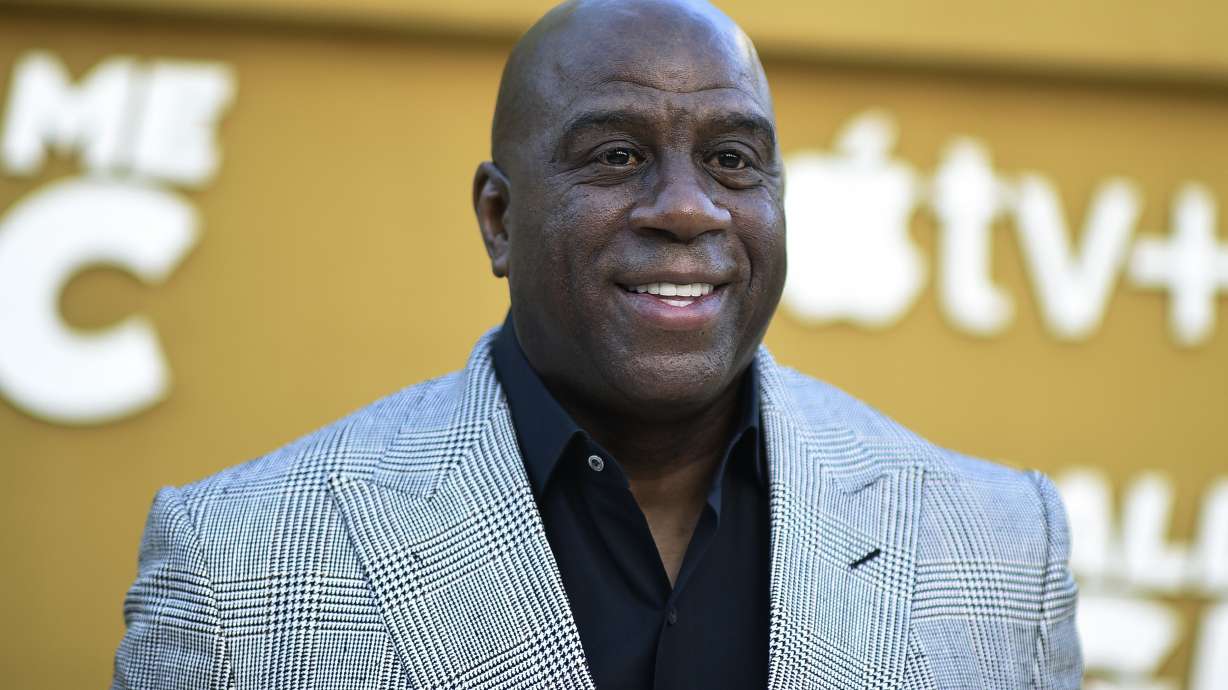 FILE - Magic Johnson arrives at the premiere of "They Call Me Magic" on Thursday, April 14, 2022, at Regency Village Theatre in Los Angeles. A group led by Josh Harris and Mitchell Rales that includes Magic Johnson has an agreement in principle to buy the NFL's Washington Commanders from longtime owner Dan Snyder for a North American professional sports team record $6 billion, according to a person with knowledge of the situation. The person spoke to The Associated Press on condition of anonymity Thursday, April 13, 2023, because the deal had not been announced.