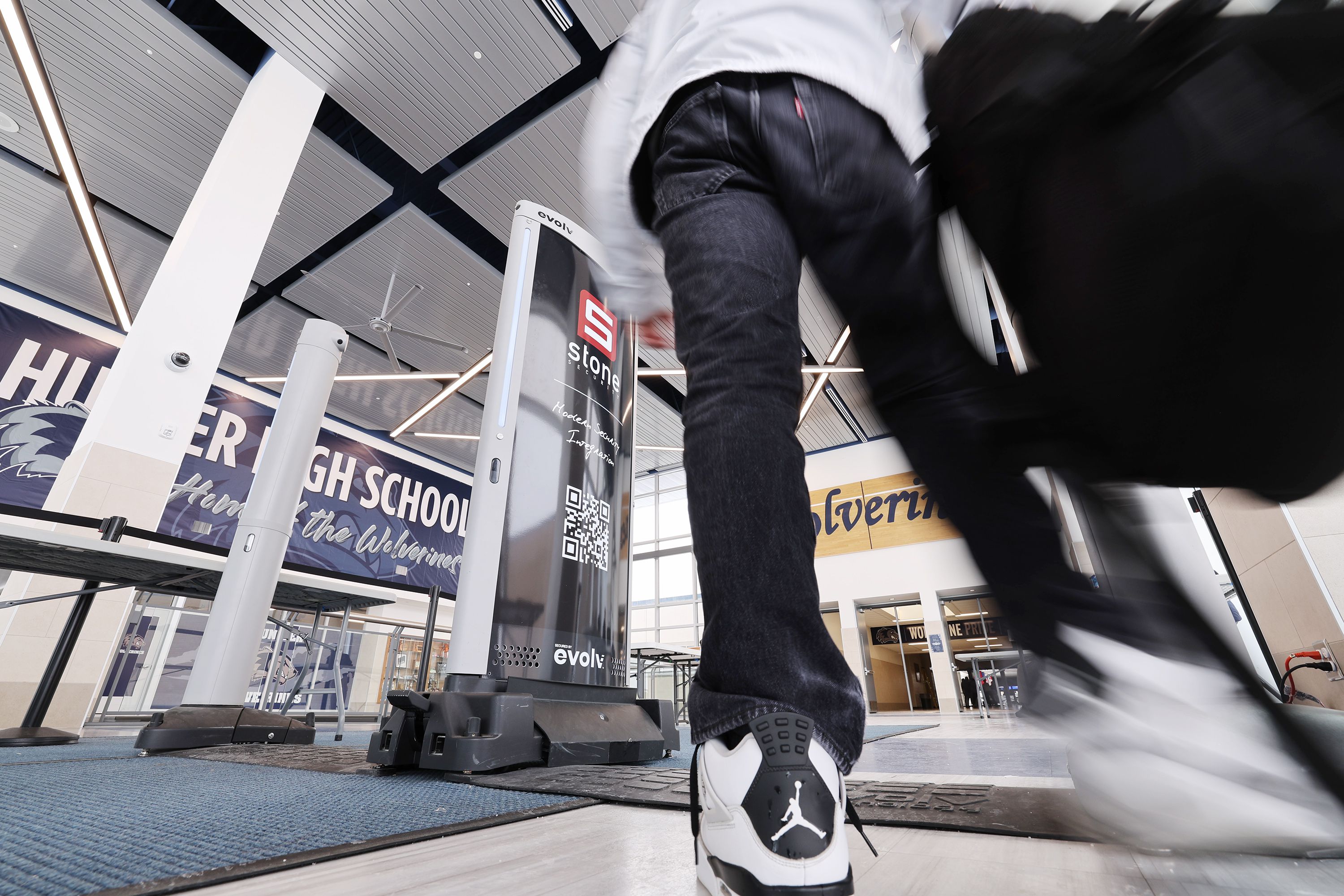 A Hunter High School student walks through the scanners on April 4. The West Valley City school is piloting a new technology that is helping to keep the school safer.