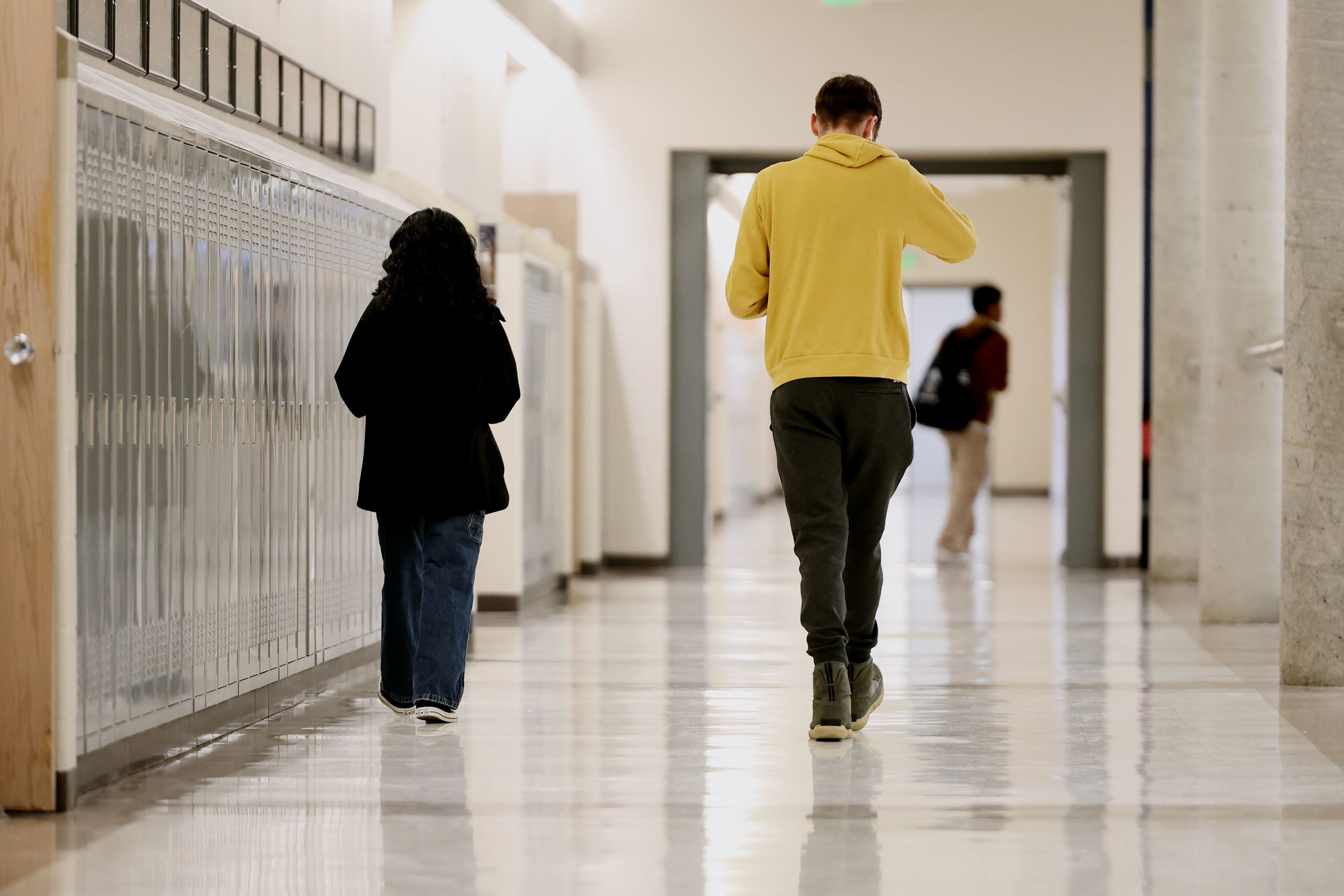 Hunter High School students walk down a hallway on April 4. The West Valley City school is piloting a new technology that is helping to keep the school safer.