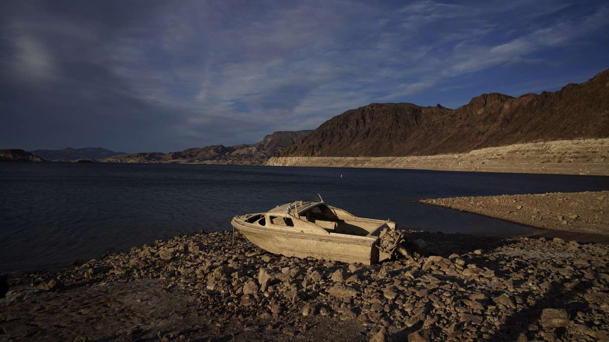 A formerly sunken boat sits high and dry along the shoreline of Lake Mead May 10, 2022, near Boulder City, Nev. Human remains found last summer at the lake have been identified as a Las Vegas man missing since July 1998.