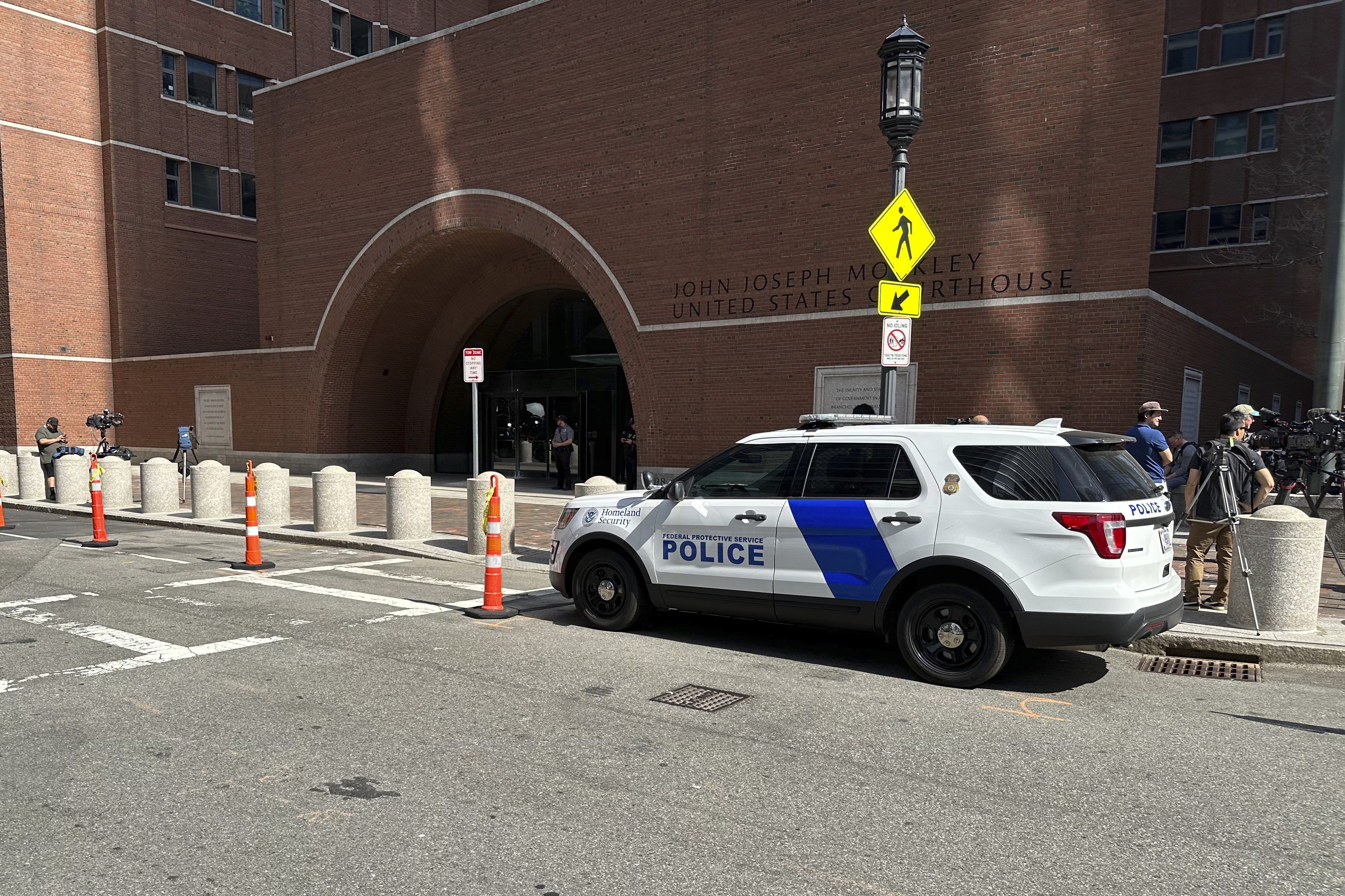 A federal police vehicle is parked outside U.S. District Court in Boston, Mass., Friday, as Massachusetts Air National Guardsman Jack Teixeira appears for an initial hearing after being accused of leaking highly classified military documents.