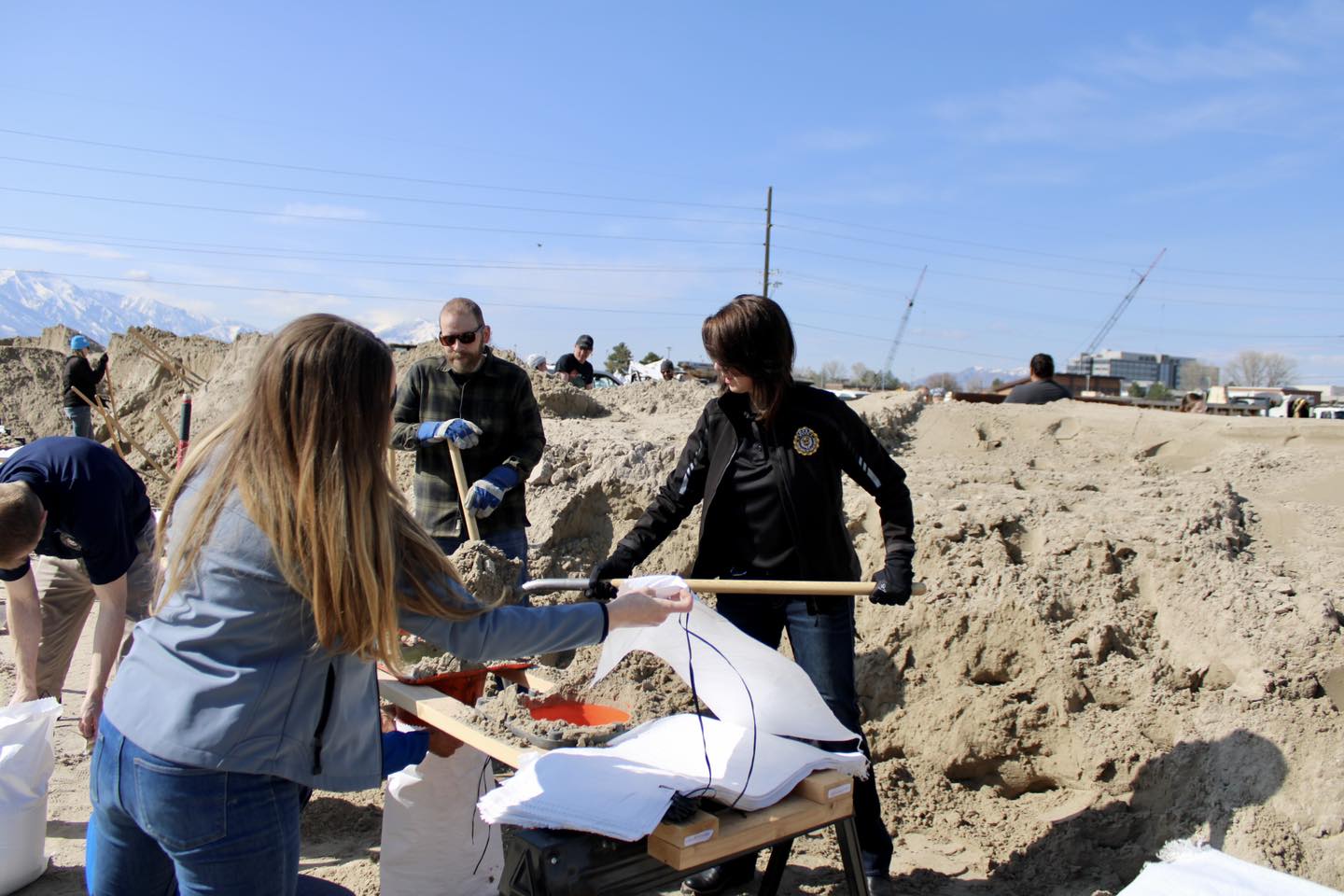 Lt. Gov. Deidre Henderson, right, fills sandbags at the Provo public works yard Friday morning. Henderson, Provo City Mayor Michelle Kaufusi and local legislators are calling on Provo residents to get involved in flood mitigation efforts.