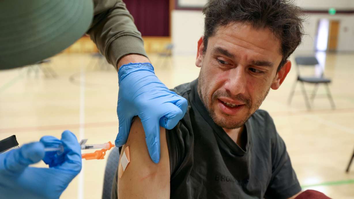 Jesus Hernandez gets a Moderna COVID-19 booster shot during a free vaccine clinic at the Sanderson Community Center in Taylorsville on Nov. 9, 2022. The Utah Department of Health and Human Services is set to stop counting cases of COVID-19 next month.