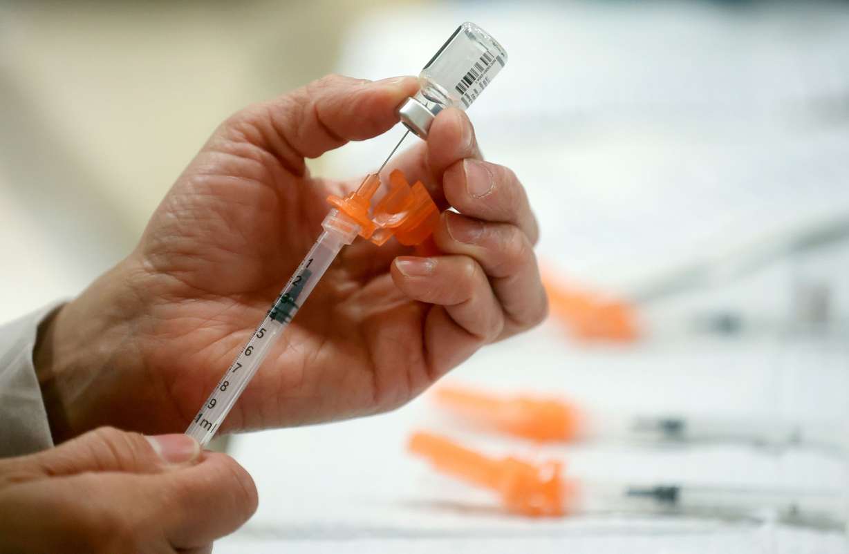 A Salt Lake County Health Department employee prepares Pfizer COVID-19 booster shots at a free vaccine clinic at the Sanderson Community Center in Taylorsville on Nov. 9, 2022.