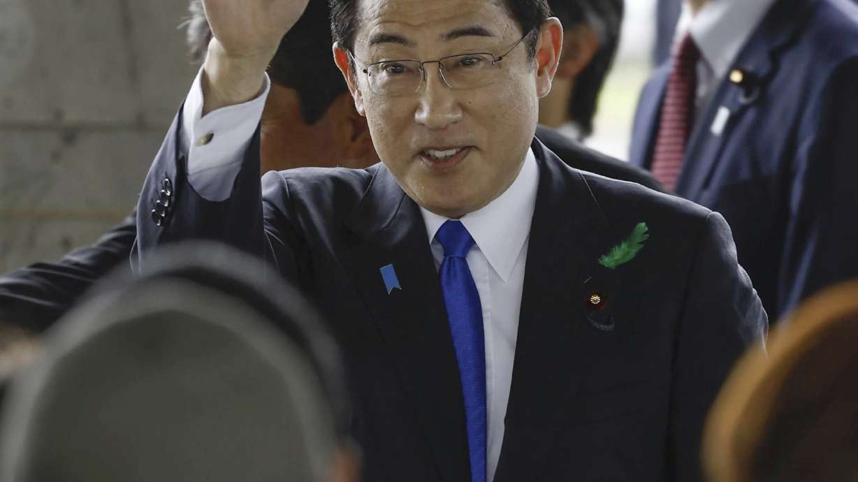 Japanese Prime Minister Fumio Kishida waves as he visits a port in Wakayama, western Japan to cheer his ruling party's candidate in a local election, Saturday, April 15, 2023. Japan’s NHK television reported Saturday that a loud explosion occurred at the western Japanese port during Kishida’s visit, but there were no injuries.