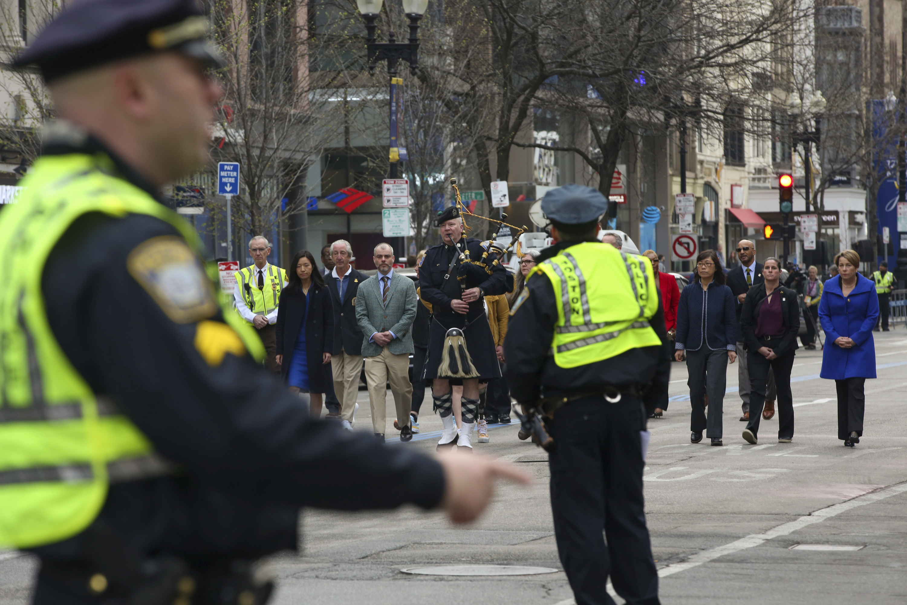 Boston police clear Boylston Street for a procession between memorials for victims of the 2013 Boston Marathon bombing, Saturday in Boston.