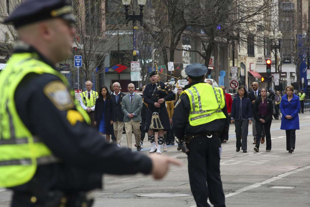 Boston police clear Boylston Street for a procession between memorials for victims of the 2013 Boston Marathon bombing, Saturday in Boston.