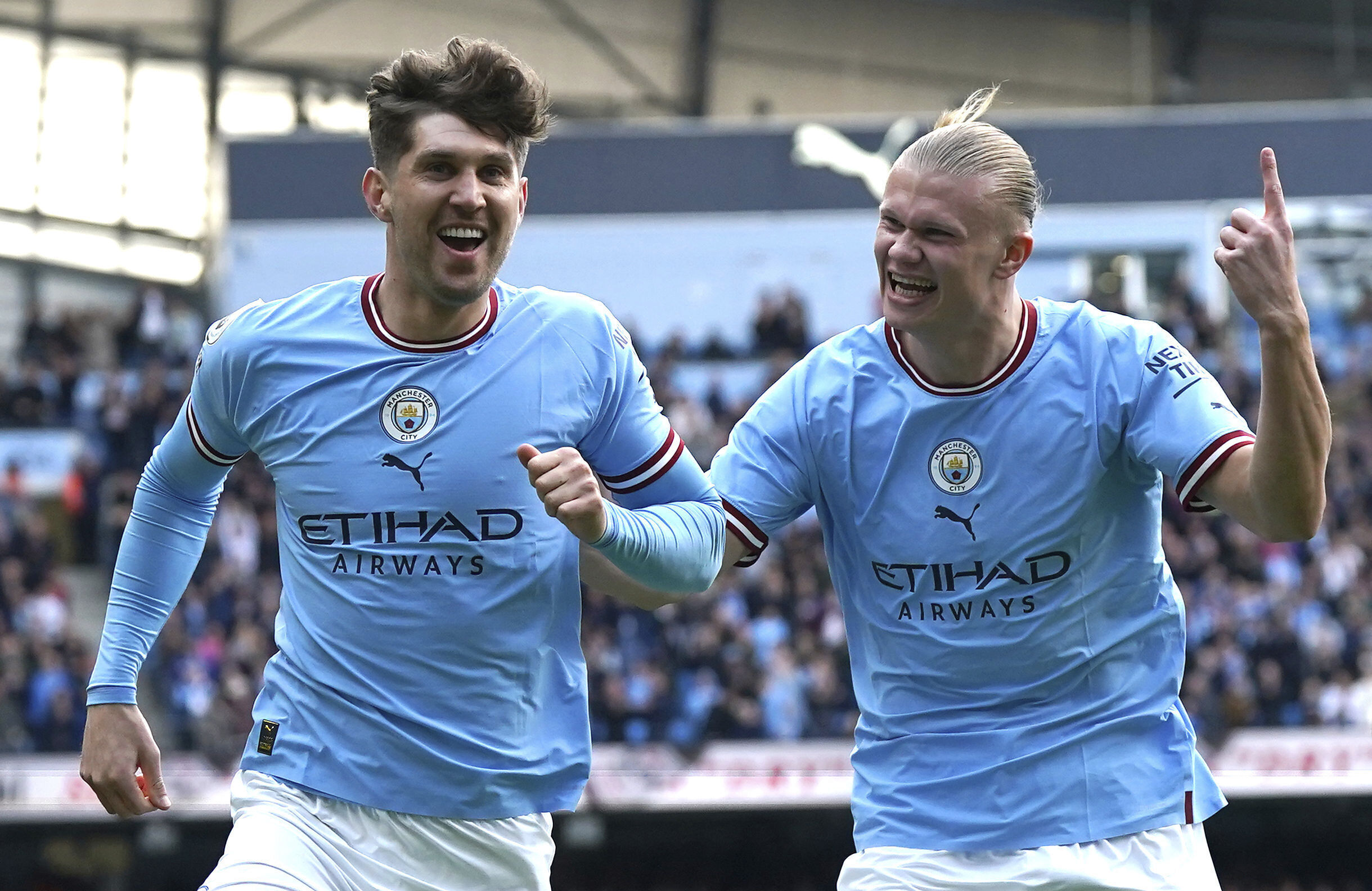 Manchester City's John Stones, left, celebrates with teammate Erling Haaland after scoring his side's opening goal during the English Premier League soccer match between Manchester City and Leicester City at Etihad Stadium in Manchester, England, Saturday, April 15, 2023. 