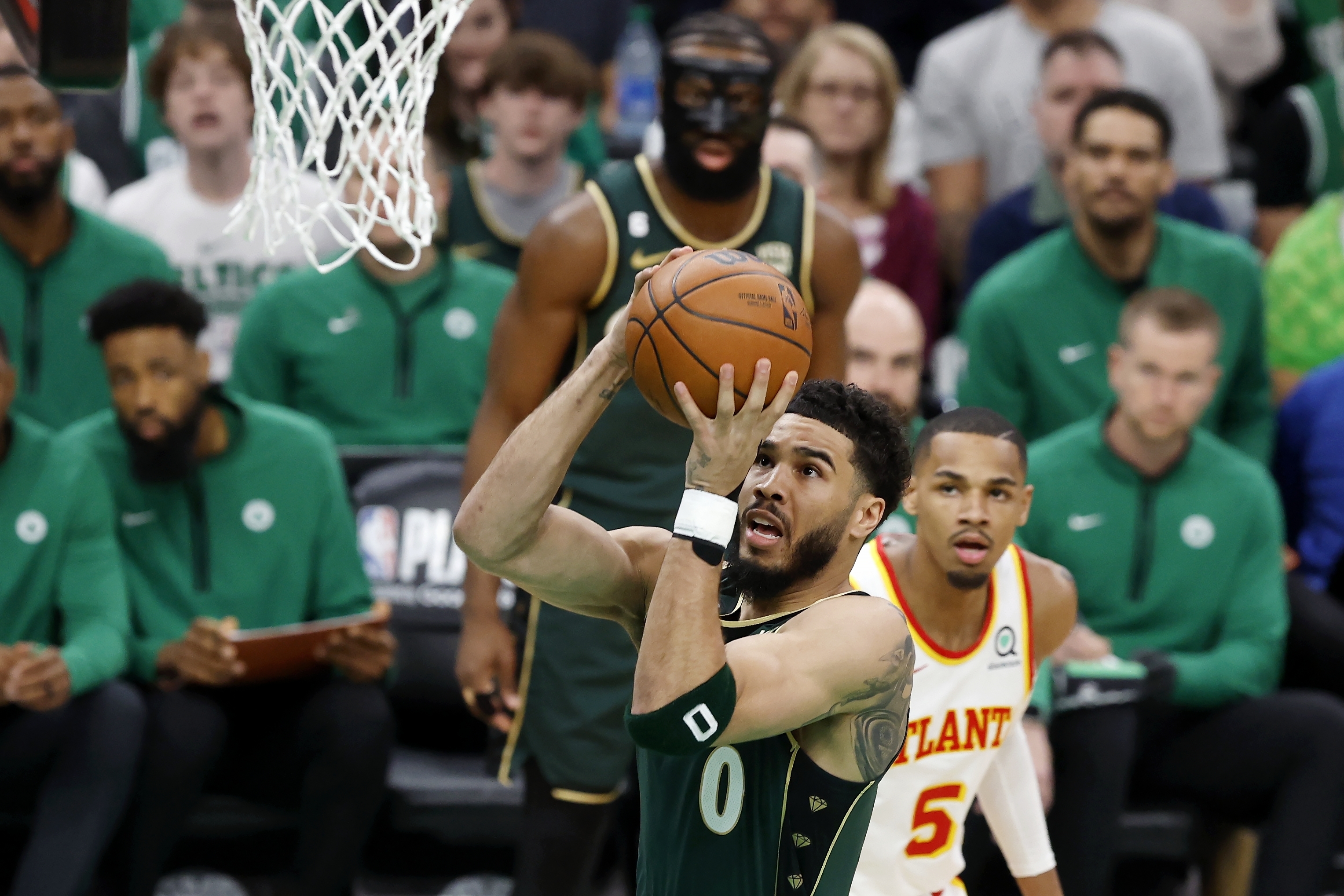 Boston Celtics' Jayson Tatum (0) shoots in front of Atlanta Hawks' Dejounte Murray (5) in the first half during Game 1 in the first round of the NBA basketball playoffs, Saturday, April 15, 2023, in Boston. 