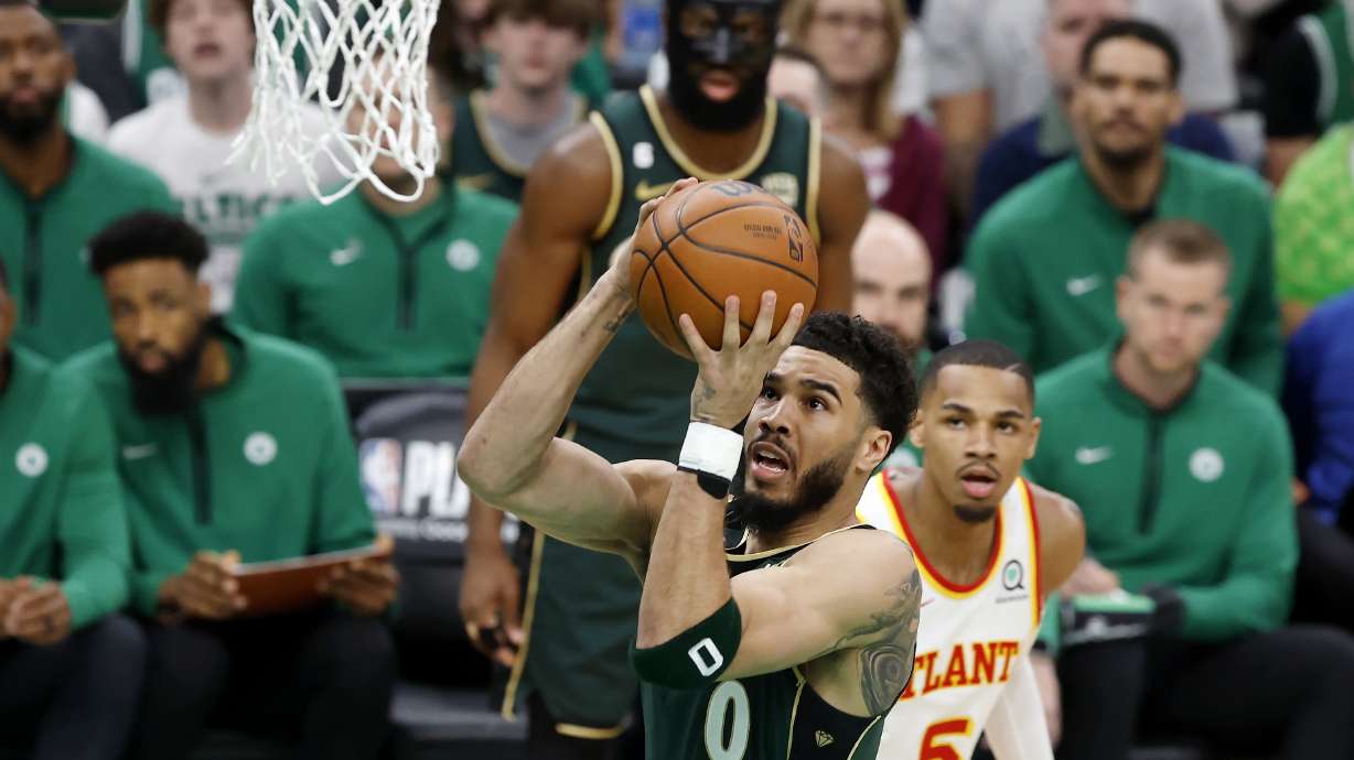 Boston Celtics' Jayson Tatum (0) shoots in front of Atlanta Hawks' Dejounte Murray (5) in the first half during Game 1 in the first round of the NBA basketball playoffs, Saturday, April 15, 2023, in Boston.