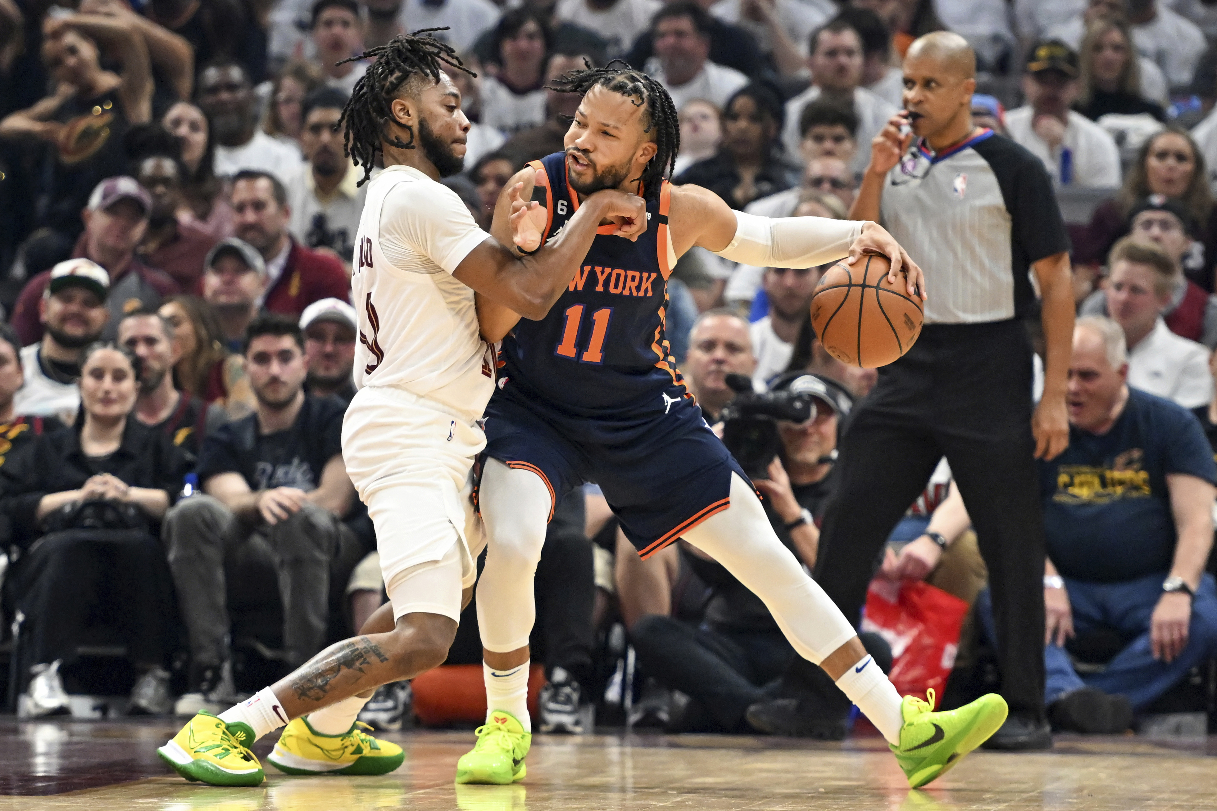 New York Knicks' Jalen Brunson (11) works against Cleveland Cavaliers' Darius Garland (10) during the first half of Game 1 in a first-round NBA basketball playoffs series Saturday, April 15, 2023, in Cleveland. 