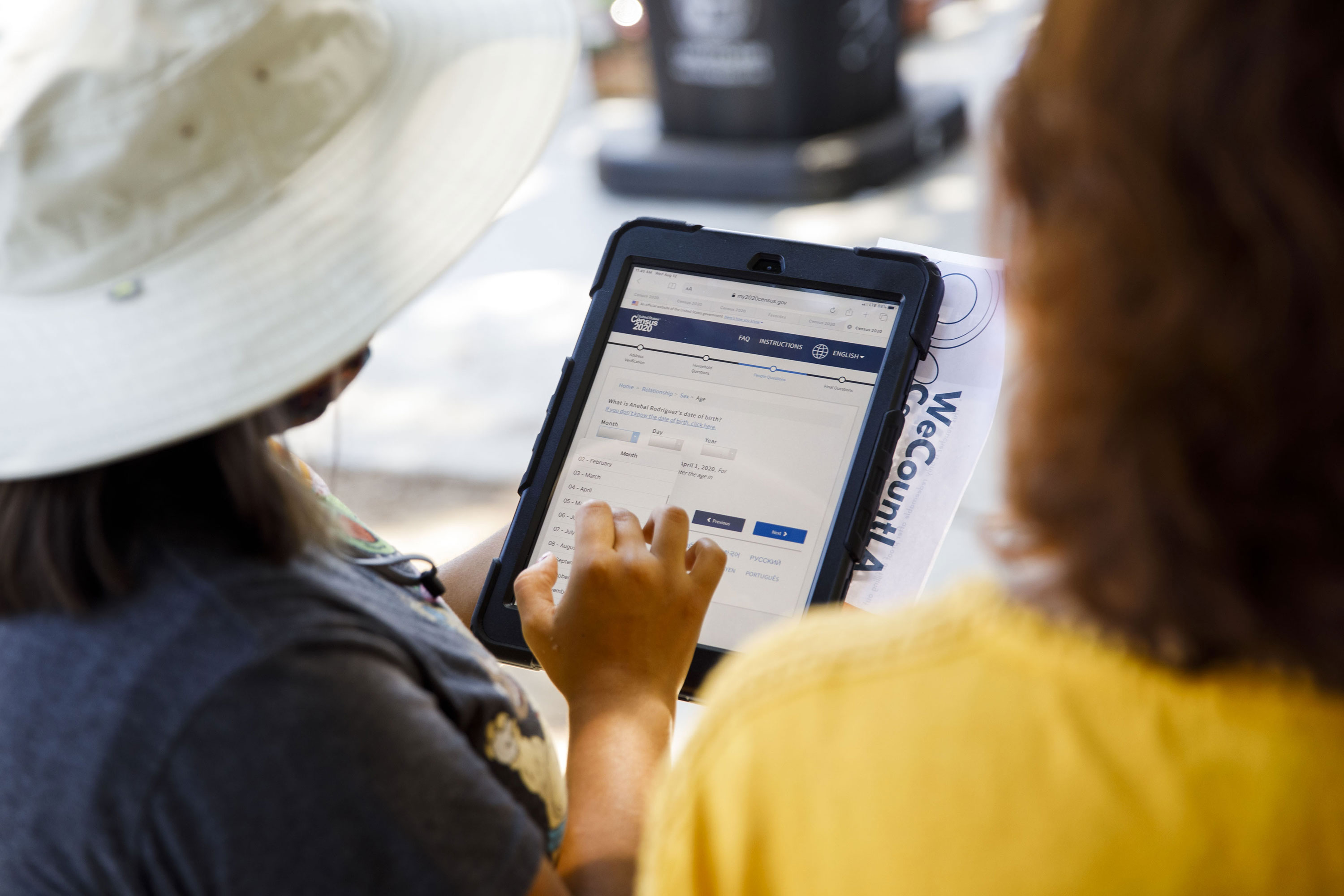 A YMCA youth ambassador conducts a Census 2020 interview during a community food distribution at a YMCA location in Los Angeles, California, on Aug. 12, 2020.