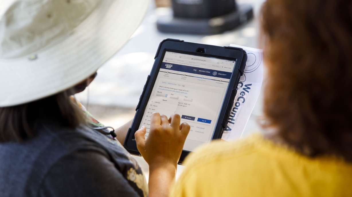 A YMCA youth ambassador conducts a Census 2020 interview during a community food distribution at a YMCA location in Los Angeles, California, on Aug. 12, 2020.