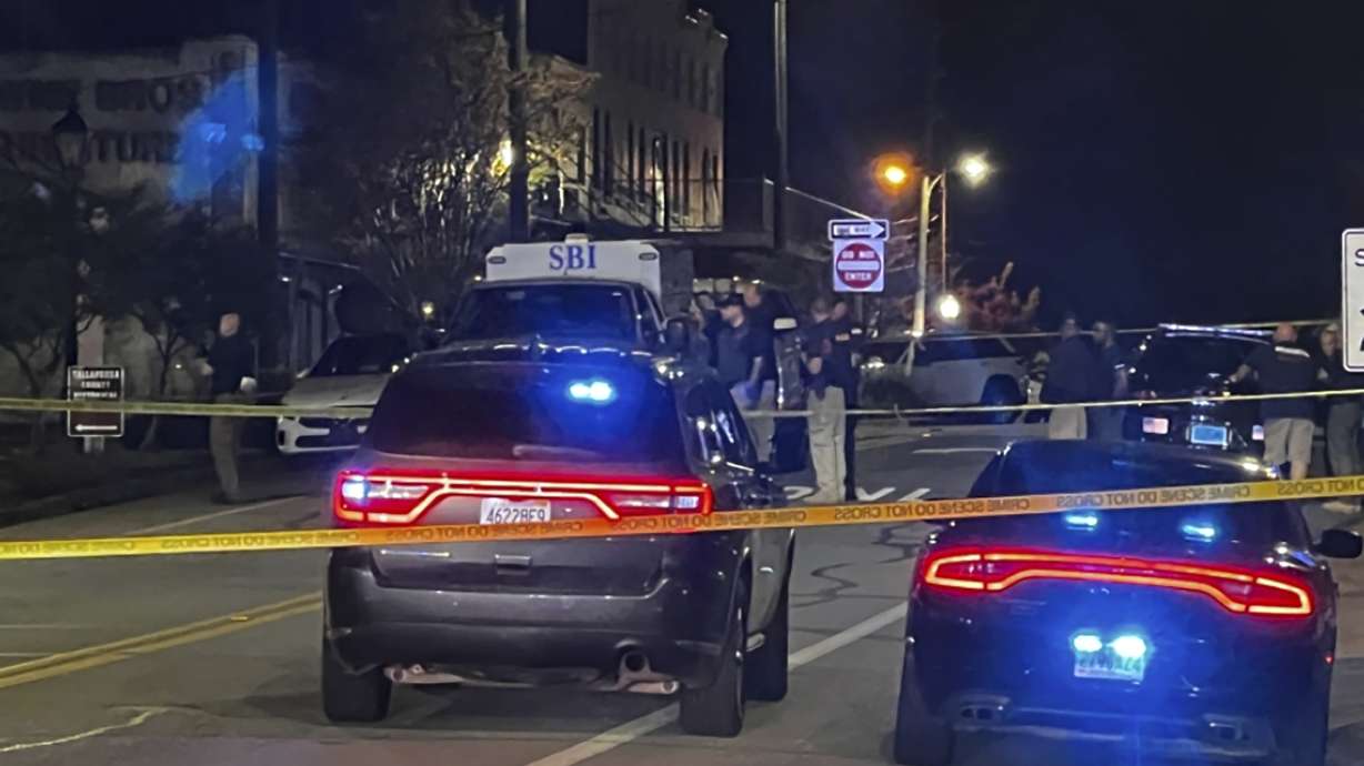 Authorities work on the scene of a shooting in Dadeville, Alabama, on Saturday. Gunfire killed a high school athlete and three other people.