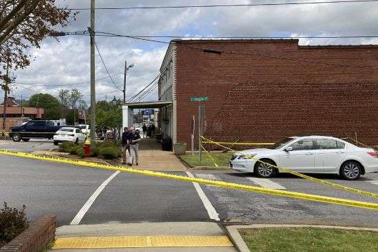 Investigators work at the site of a fatal shooting in downtown Dadeville, Alabama, on Sunday. Several were killed during a shooting at a birthday party Saturday night, the Alabama Law Enforcement Agency said.