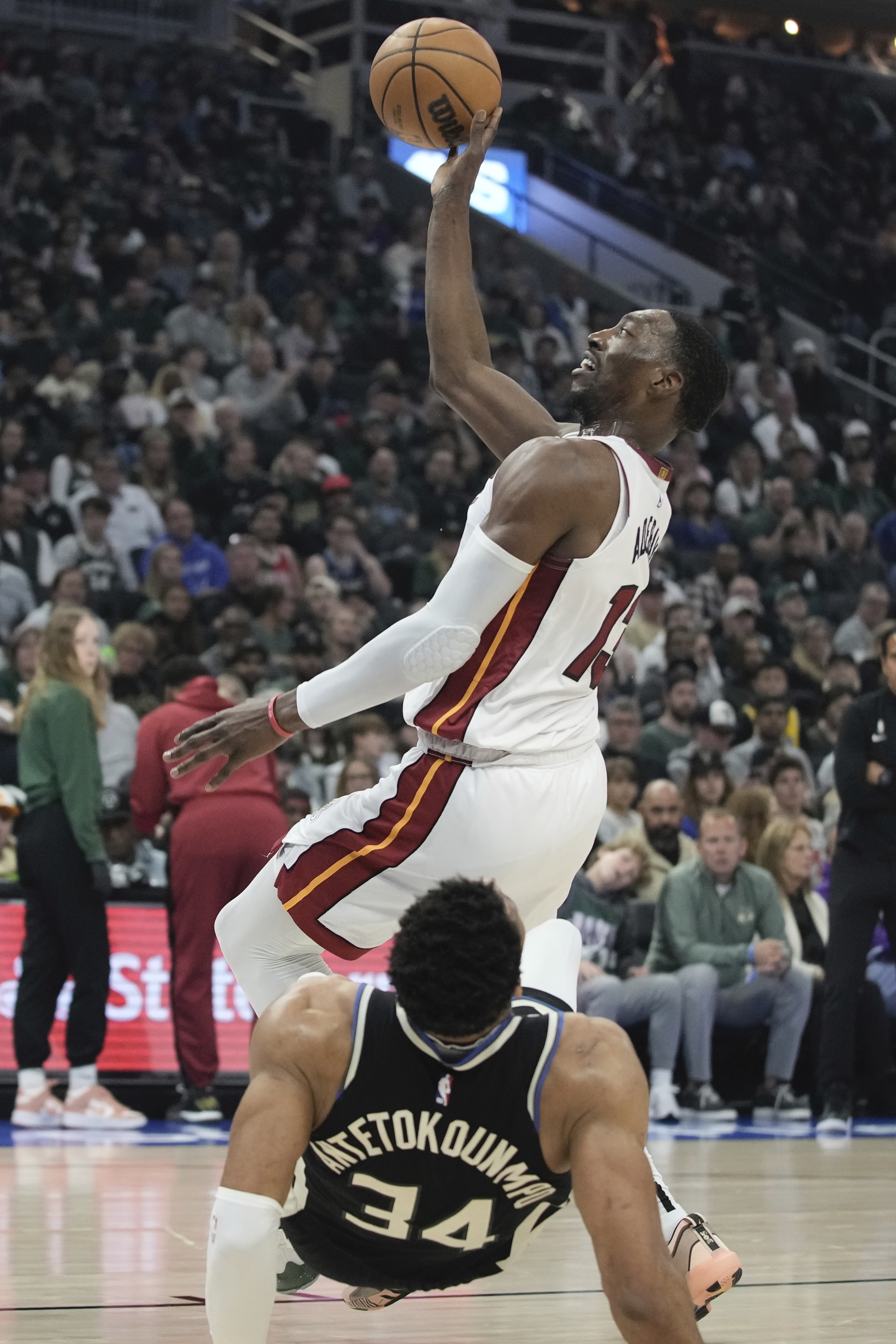 Milwaukee Bucks' Giannis Antetokounmpo fouls Miami Heat's Bam Adebayo during the first half in Game 1 of an NBA basketball first-round playoff game Sunday, April 16, 2023, in Milwaukee. 