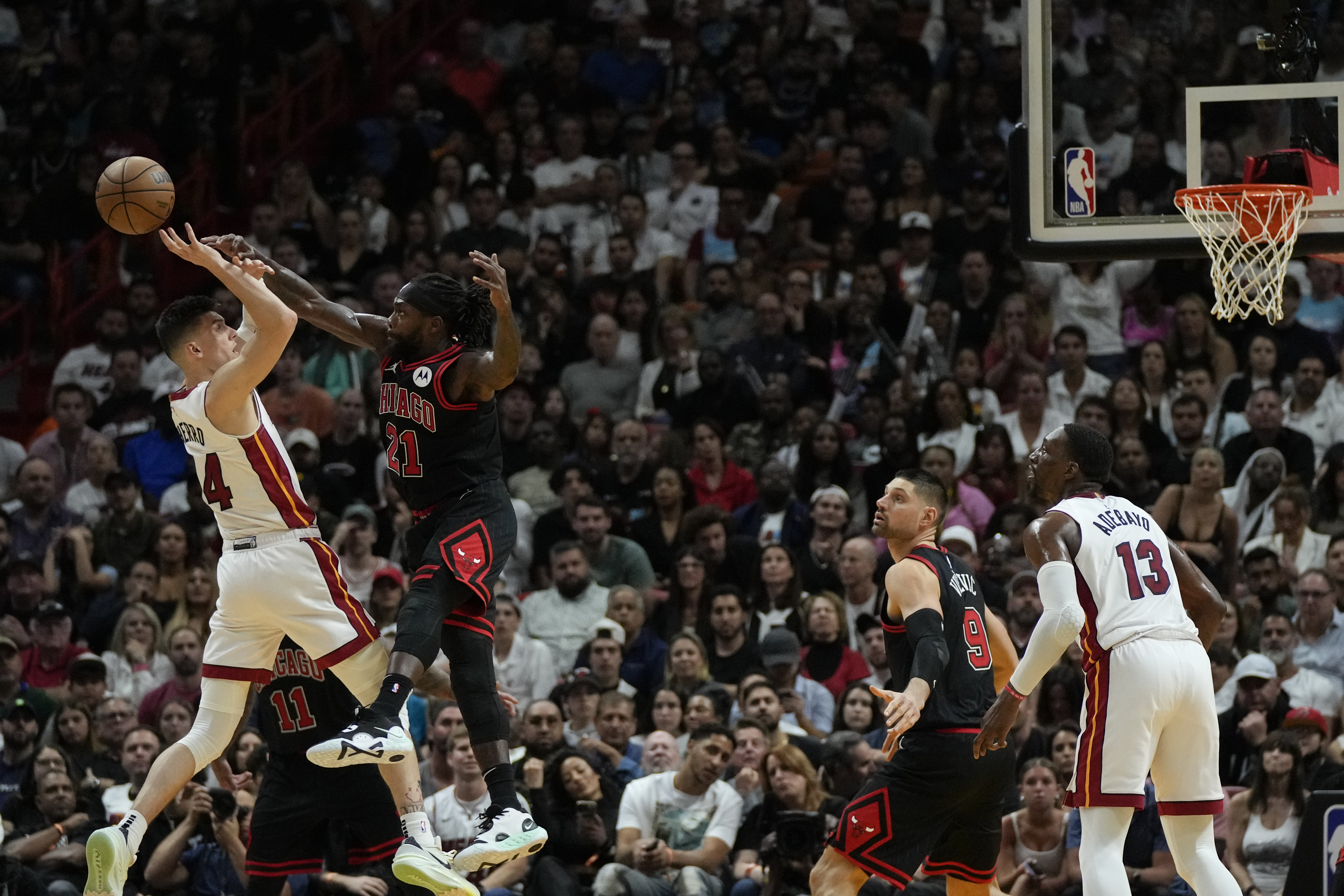 Miami Heat guard Tyler Herro (14) is fouled by Chicago Bulls guard Patrick Beverley (21) as he shoots during the second half of an NBA basketball play-in tournament game, Friday, April 14, 2023, in Miami. 