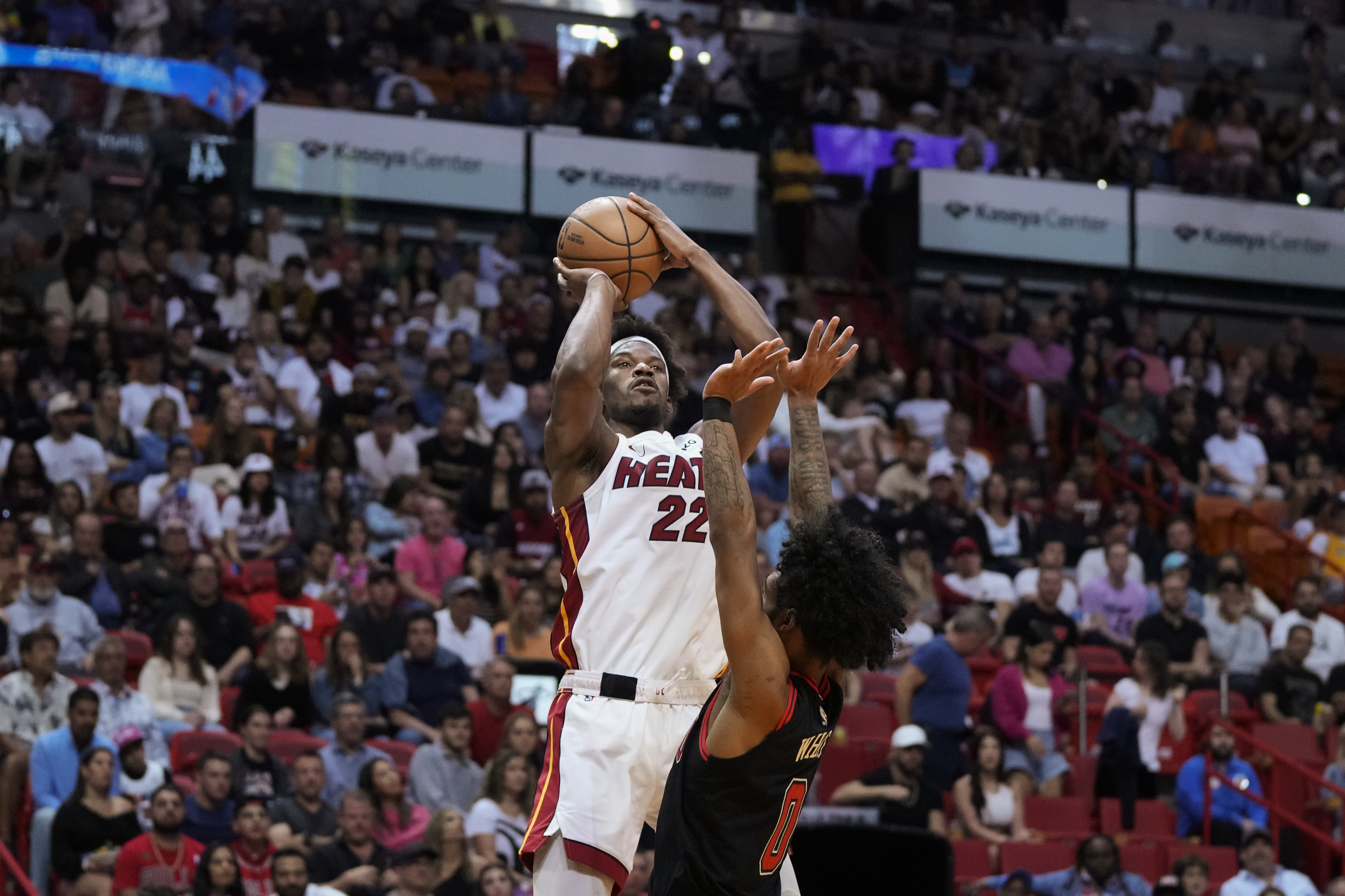 Miami Heat forward Jimmy Butler (22) shoots over Chicago Bulls guard Coby White (0) during the first half of an NBA basketball play-in tournament game, Friday, April 14, 2023, in Miami. 