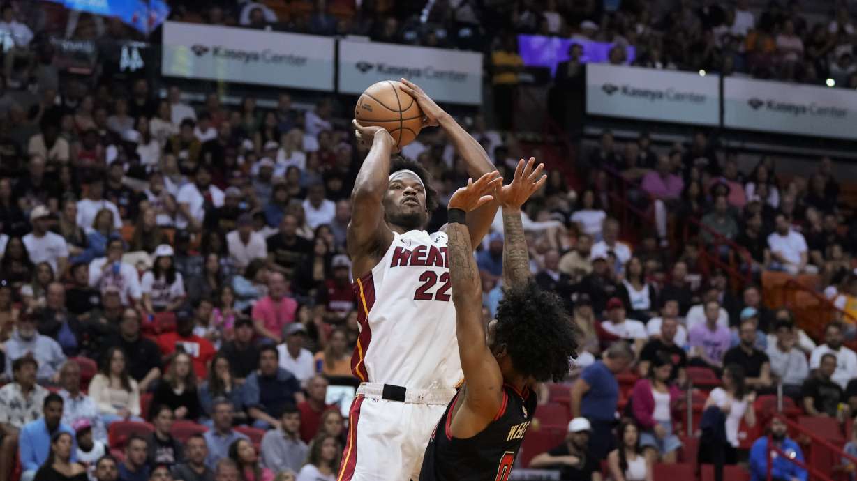 Miami Heat forward Jimmy Butler (22) shoots over Chicago Bulls guard Coby White (0) during the first half of an NBA basketball play-in tournament game, Friday, April 14, 2023, in Miami.