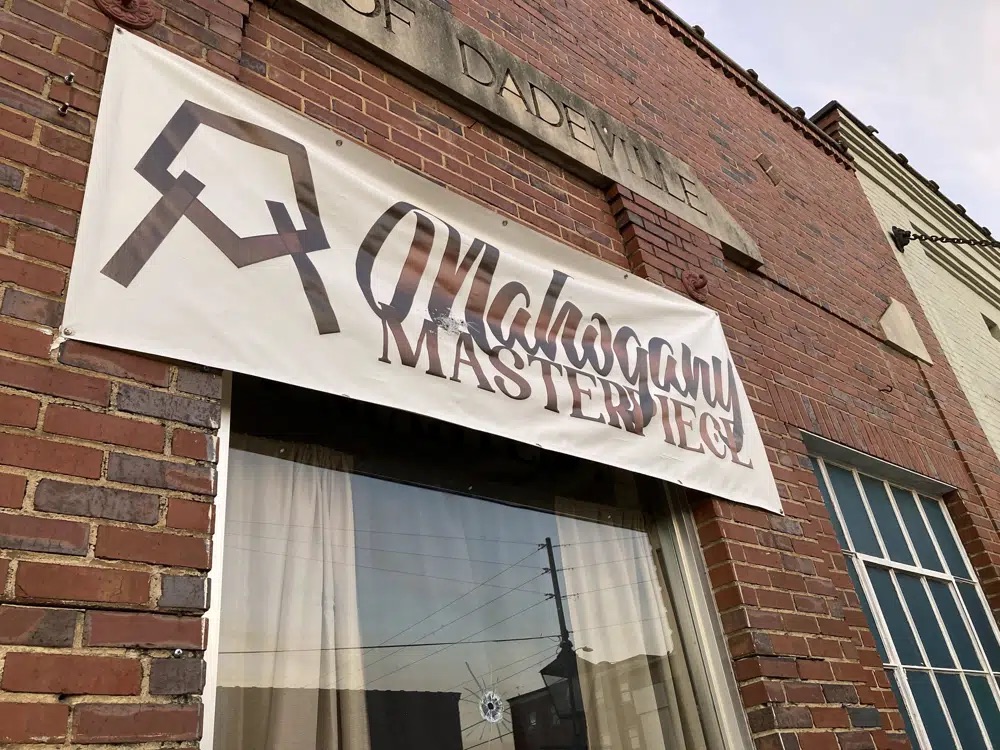 A bullet hole is visible in the glass transom over the door at the Mahogany Masterpiece dance studio in Dadeville, Ala., on Sunday. Several people were killed and multiple others injured in a shooting at a birthday party at the dance studio the previous night.