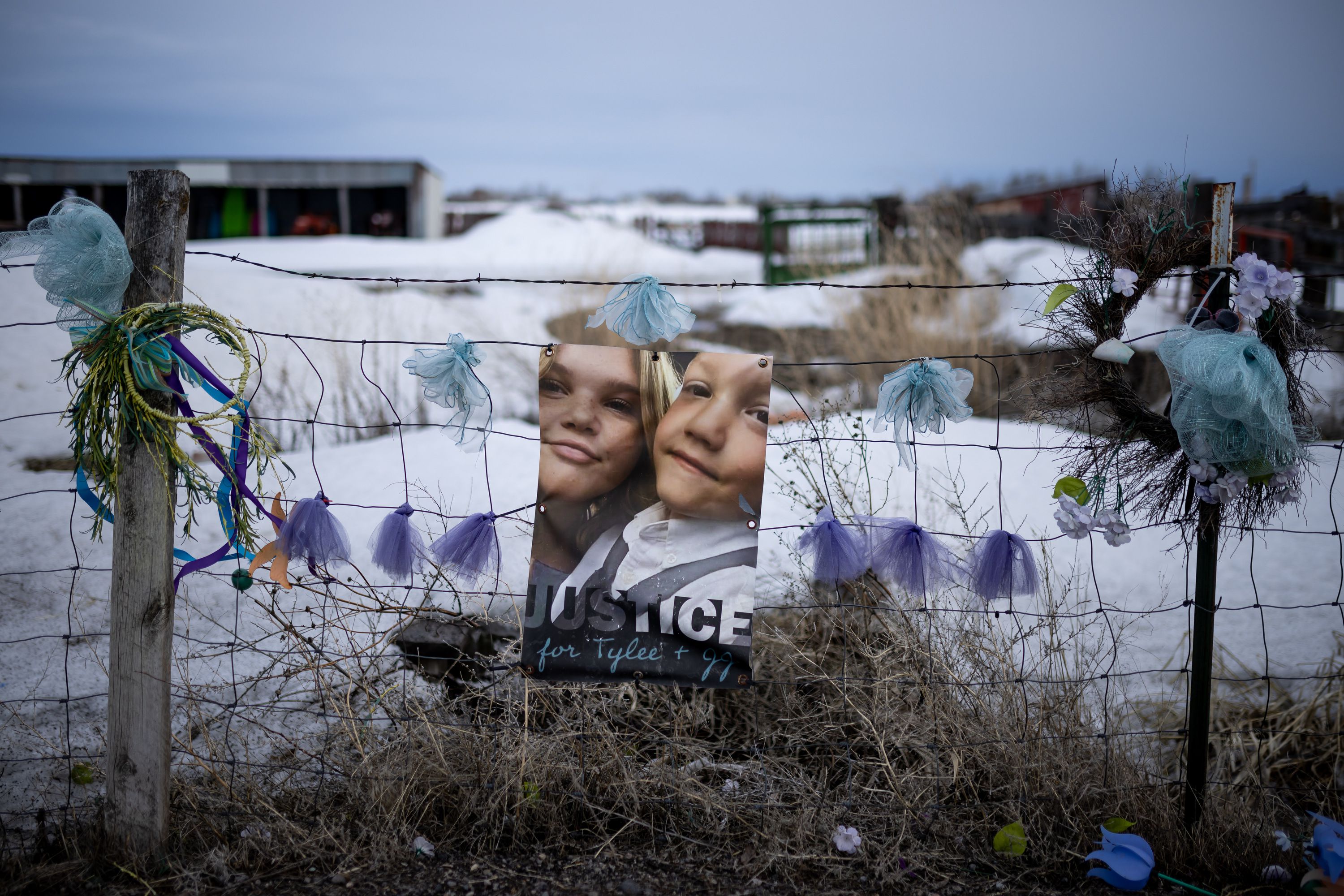 A memorial to Tylee Ryan and JJ Vallow is set up on a neighbor’s fence just across the street from Chad Daybell’s property in Salem, Idaho, on March 29.