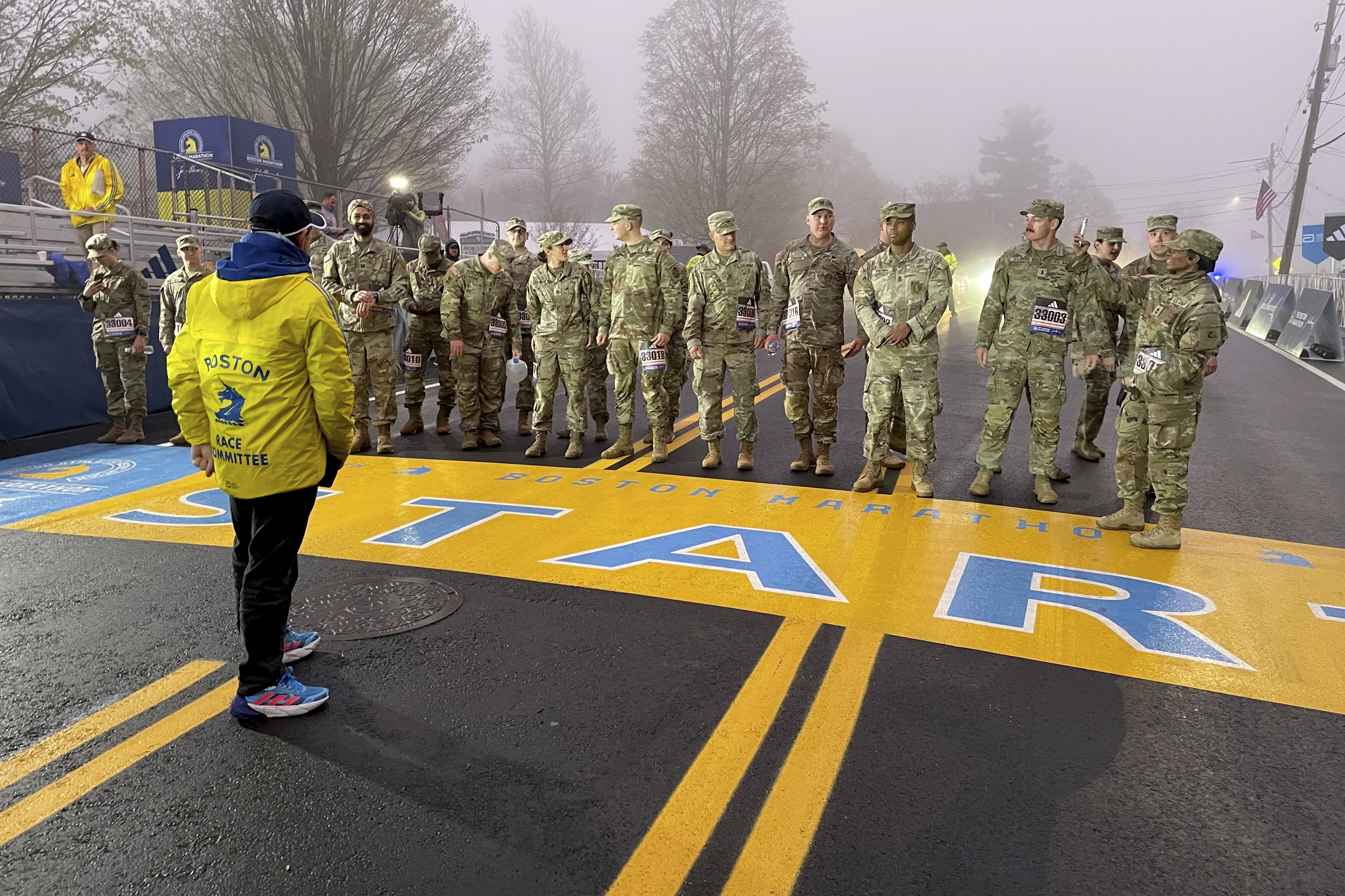 Boston Marathon Race Director Dave McGillivray sends out a group of about 20 from the Massachusetts National Guard, which walks the course annually, announcing the start of the 127th marathon Monday, April 17, 2018. 