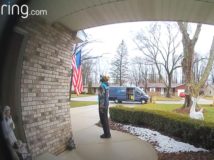 An Amazon driver salutes the American flag after delivering a package in Michigan.