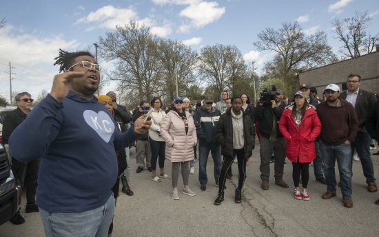 Thea Davis, pastor at Restore Community Church, left, addresses a crowd of protestors before a march Sunday in Kansas City, Missouri, to bring attention to the shooting of Ralph Yarl, 16, who was shot when he went to the wrong Kansas City house to pick up his brothers.