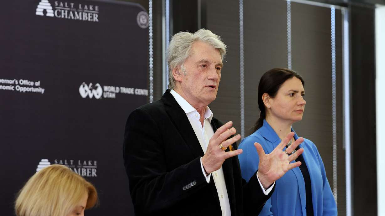 Former Ukrainian President Viktor Yushchenko, with the assistance of an interpreter, speaks to a group gathered at the World Trade Center Utah office in Salt Lake City on Monday.