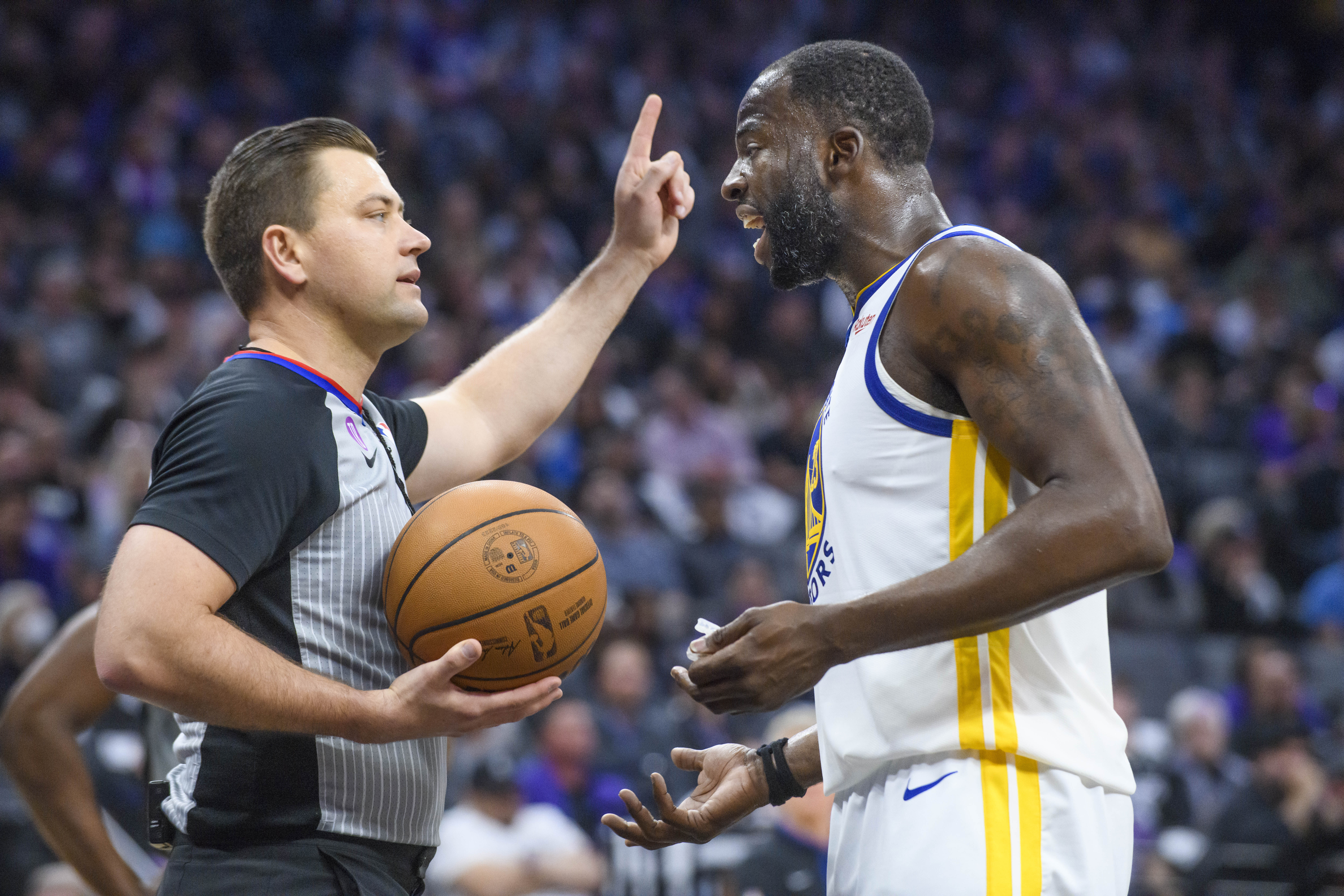 Golden State Warriors forward Draymond Green, right, argues with referee Gediminas Petraitis in the first half during Game 1 in the first round of the NBA basketball playoffs against the Sacramento Kings in Sacramento, Calif., Monday, April 17, 2023. 