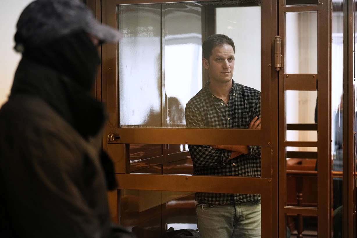 Wall Street Journal reporter Evan Gershkovich stands in a glass cage in a courtroom at the Moscow City Court, in Moscow, Russia, Tuesday.