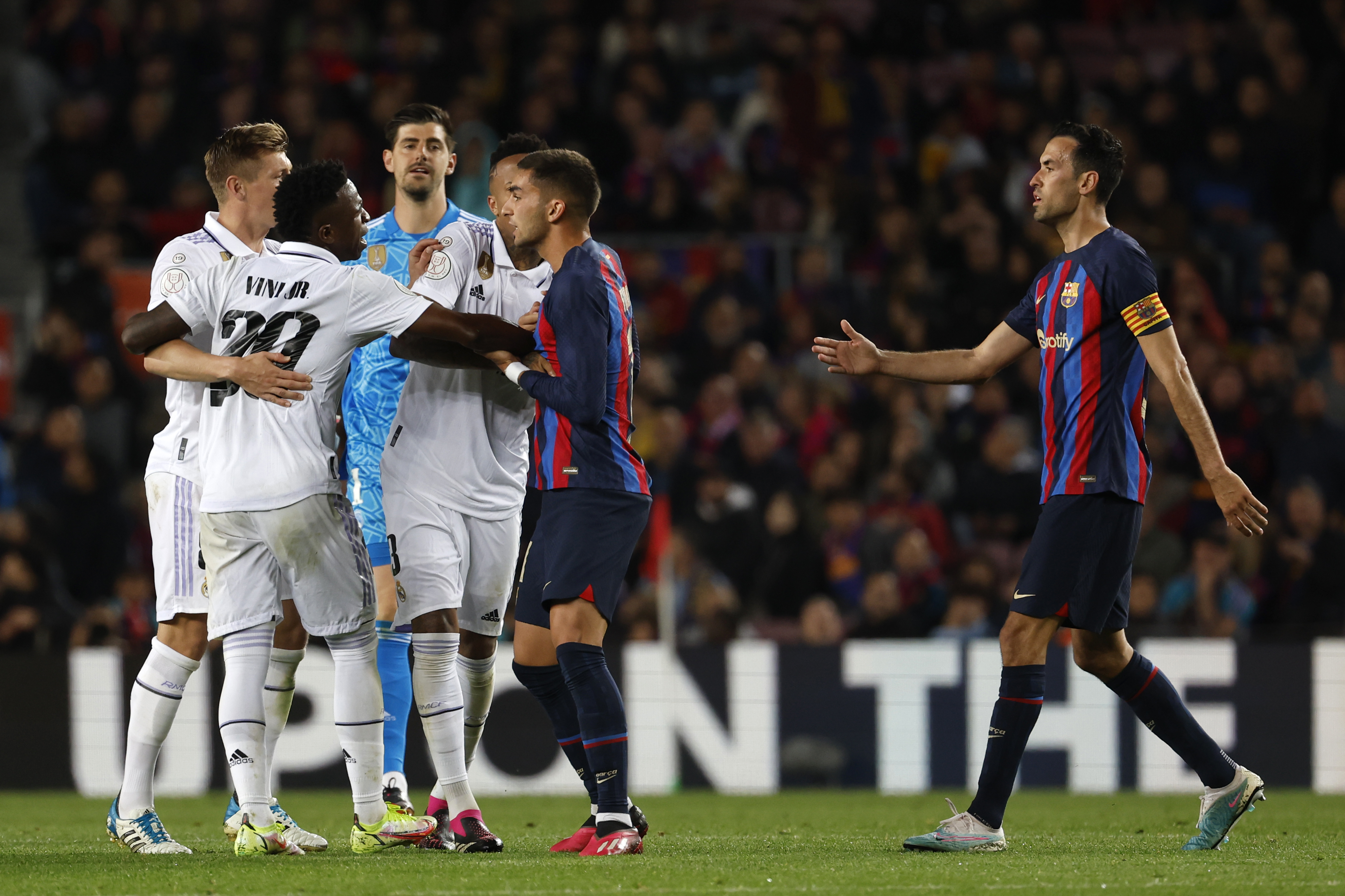 Real Madrid's Vinicius Junior, left, scuffles with Barcelona's Ferran Torres, second right, during the Spanish Copa del Rey semifinal, second leg soccer match between Barcelona and Real Madrid at the Camp Nou stadium in Barcelona, Spain, Wednesday, April 5, 2023.