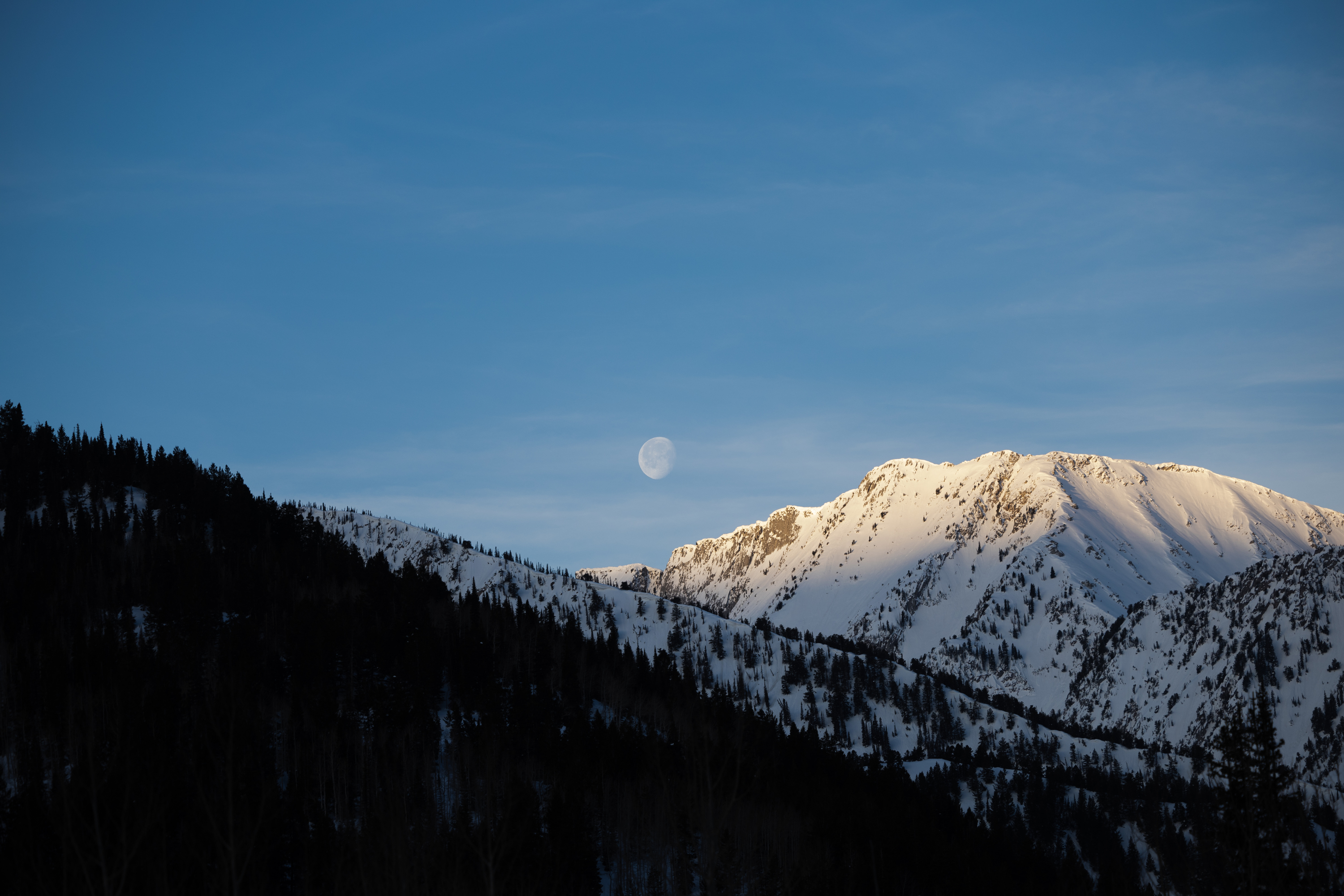 The moon is seen above the Wasatch Mountain range from Alta on April 9. Areas along the mountain range may receive another 6 to 12 inches of snow by the end of Tuesday. 
