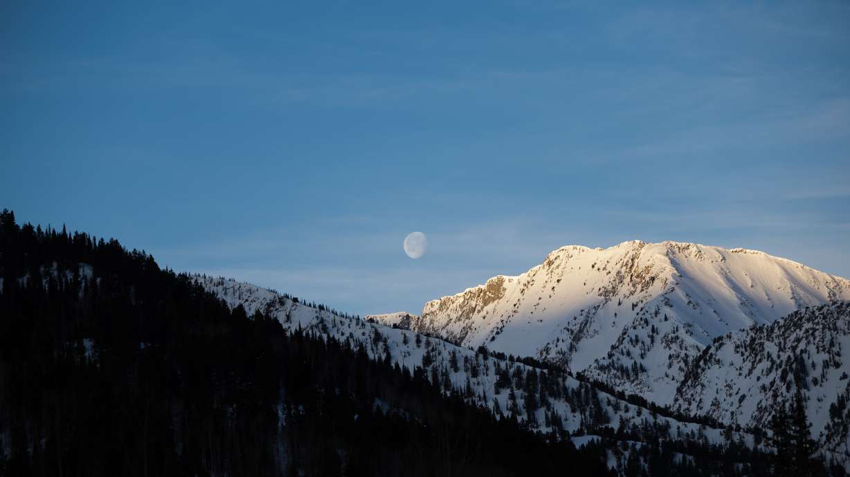 The moon is seen above the Wasatch Mountain range from Alta on April 9. Areas along the mountain range may receive another 6 to 12 inches of snow by the end of Tuesday.