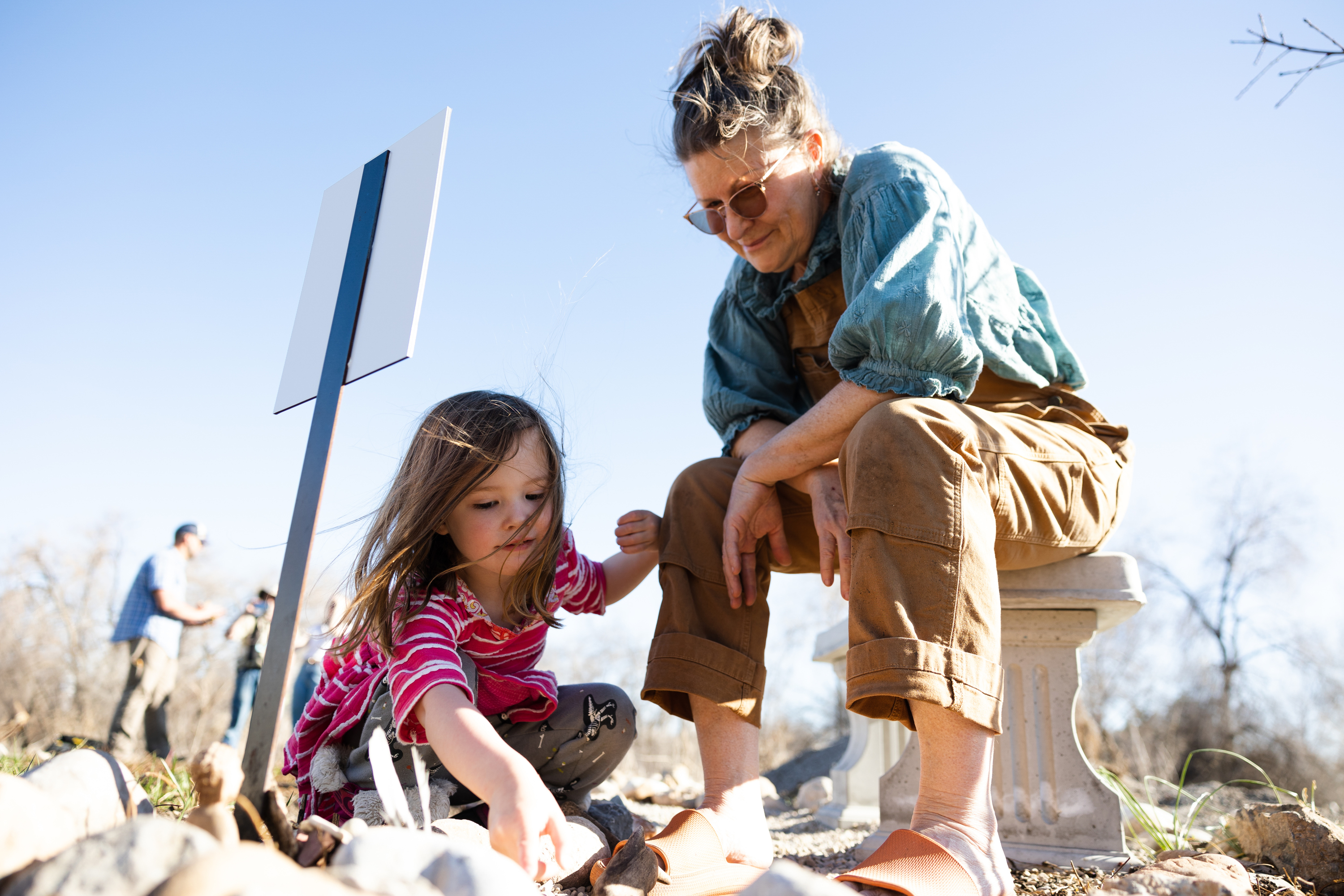 Kimberly Vanderburg-Murphy shows Lilinoe Arvin, 3, a memorial for her daughter Hali Vanderburg-Murphy at the Og-Woi People's Garden in Salt Lake City on April 10.