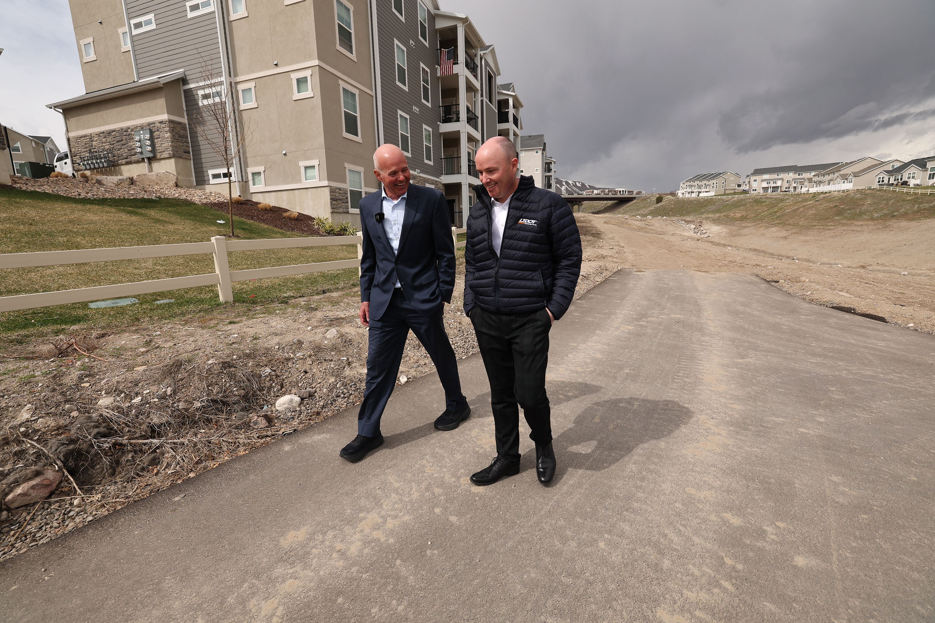 Carlos Braceras, executive director of the Utah Department of Transportation, and Gov. Spencer Cox talk in Herriman after attending a ceremonial bill signing related to managing growth in the state on Tuesday.