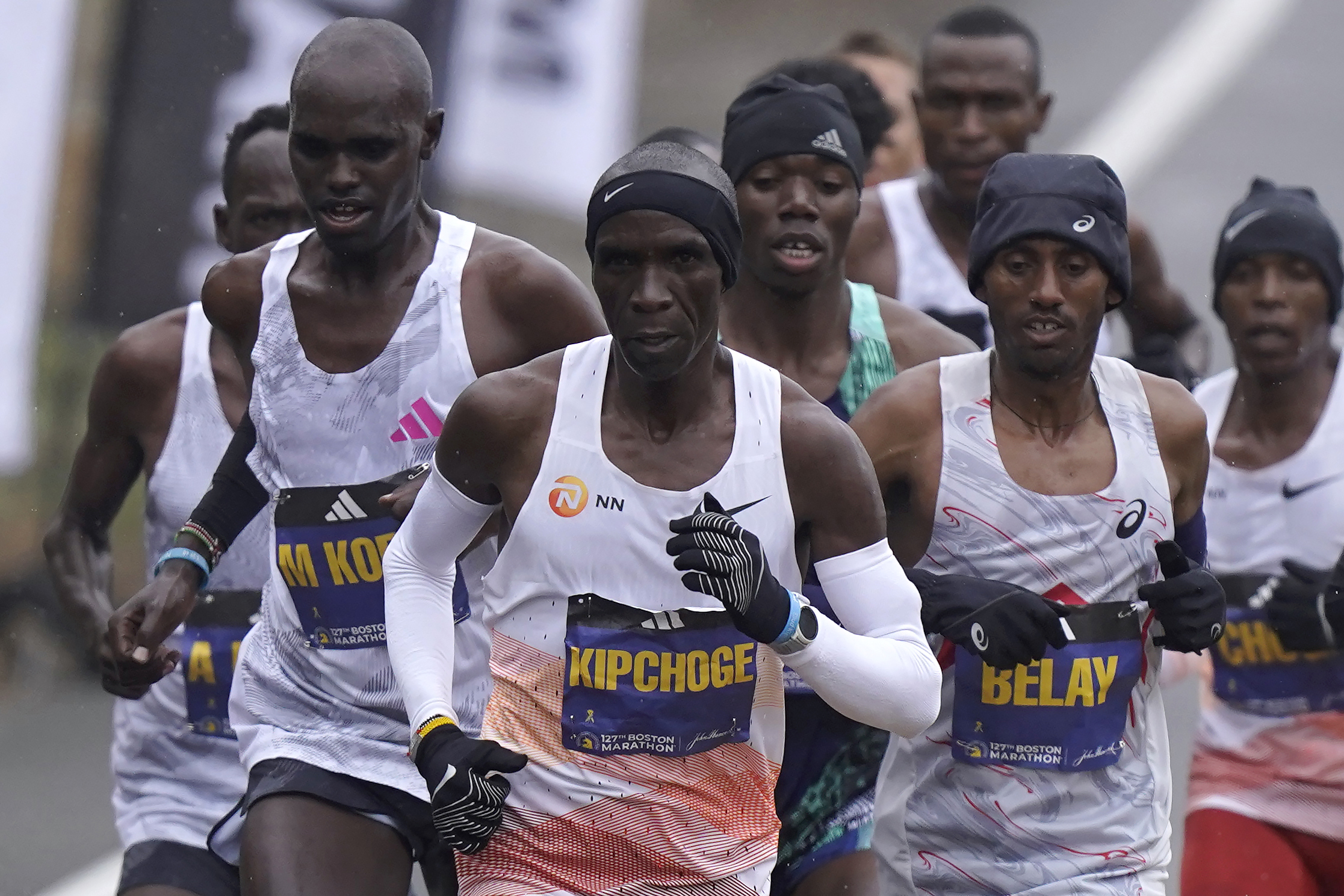 Eliud Kipchoge, of Kenya, center, runs ahead of Andualem Belay, of Ethiopia, second from right, at the front of a group of elite men, along the course of the 127th Boston Marathon, Monday, April 17, 2023, in Framingham, Mass. 