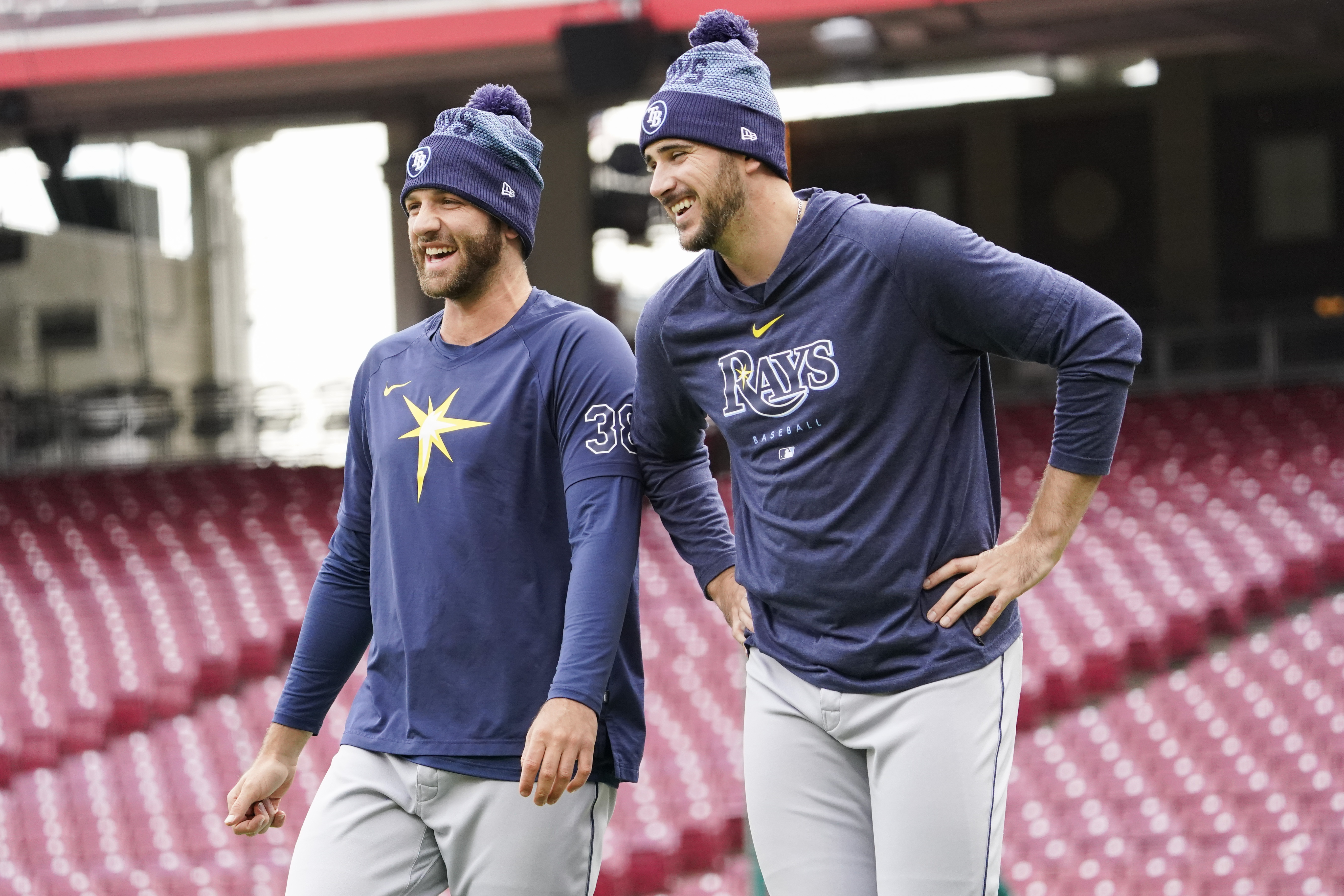 Tampa Bay Rays pitchers Colin Poche, left, and Jeffrey Springs, right, laugh during batting practice before a baseball game against the Cincinnati Reds, Monday, April 17, 2023, in Cincinnati. 
