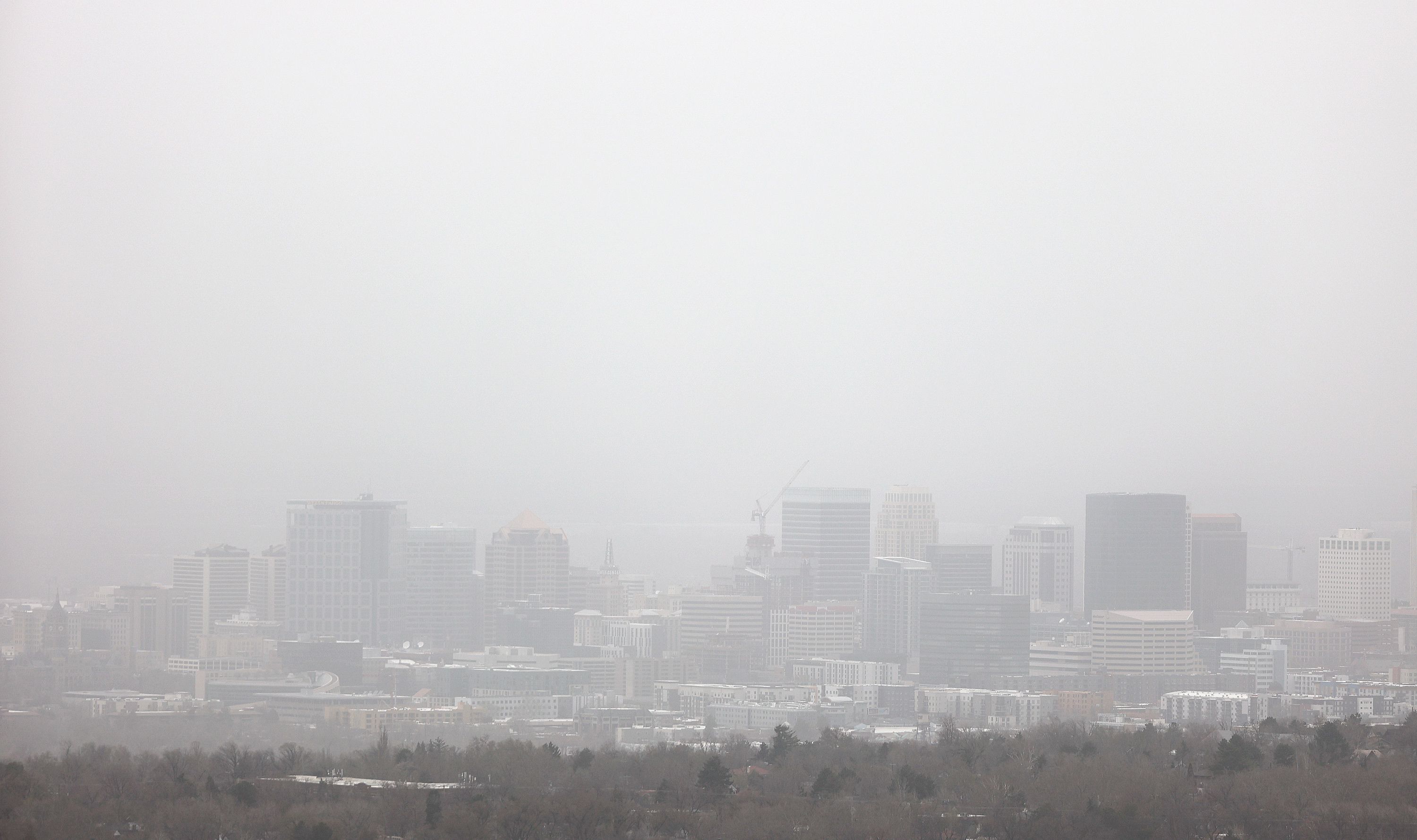 Visibility is limited as dust blows over Salt Lake City during a windstorm on Tuesday. Fine particulate readings in Tooele were well above the federal threshold imposed by the U.S. Environmental Protection Agency.