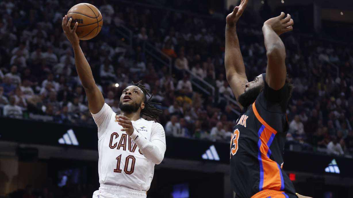Cleveland Cavaliers guard Darius Garland (10) shoots against New York Knicks center Mitchell Robinson during the first half of Game 2 of an NBA basketball first-round playoff series Tuesday, April 18, 2023, in Cleveland.