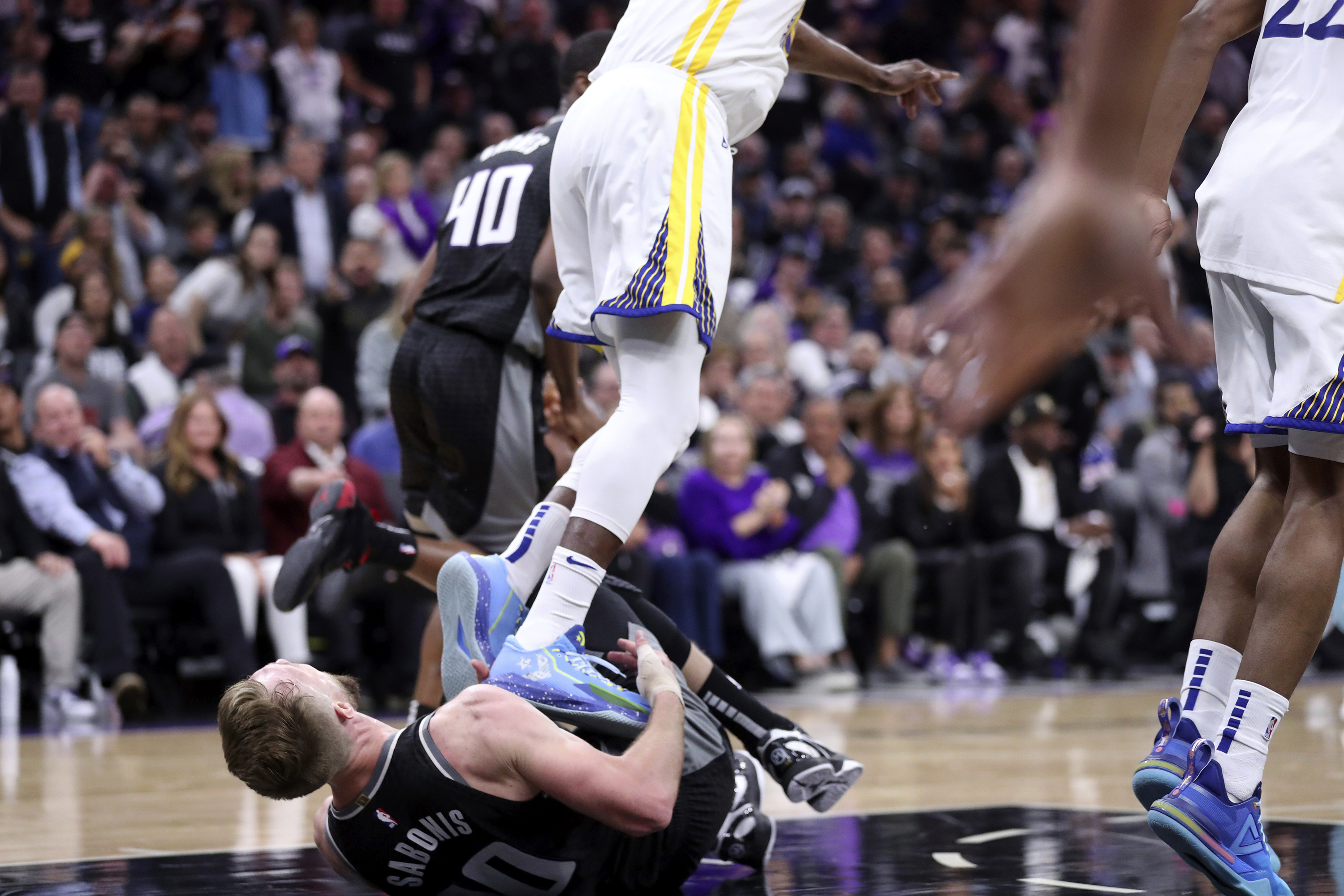 Golden State Warriors' Draymond Green stomps on Sacramento Kings' Domantas Sabonis resulting in a flagrant 2 foul during fourth quarter of Game 2 in the first round of the NBA basketball playoffs in Sacramento, Calif., on Monday, April 17, 2023. 