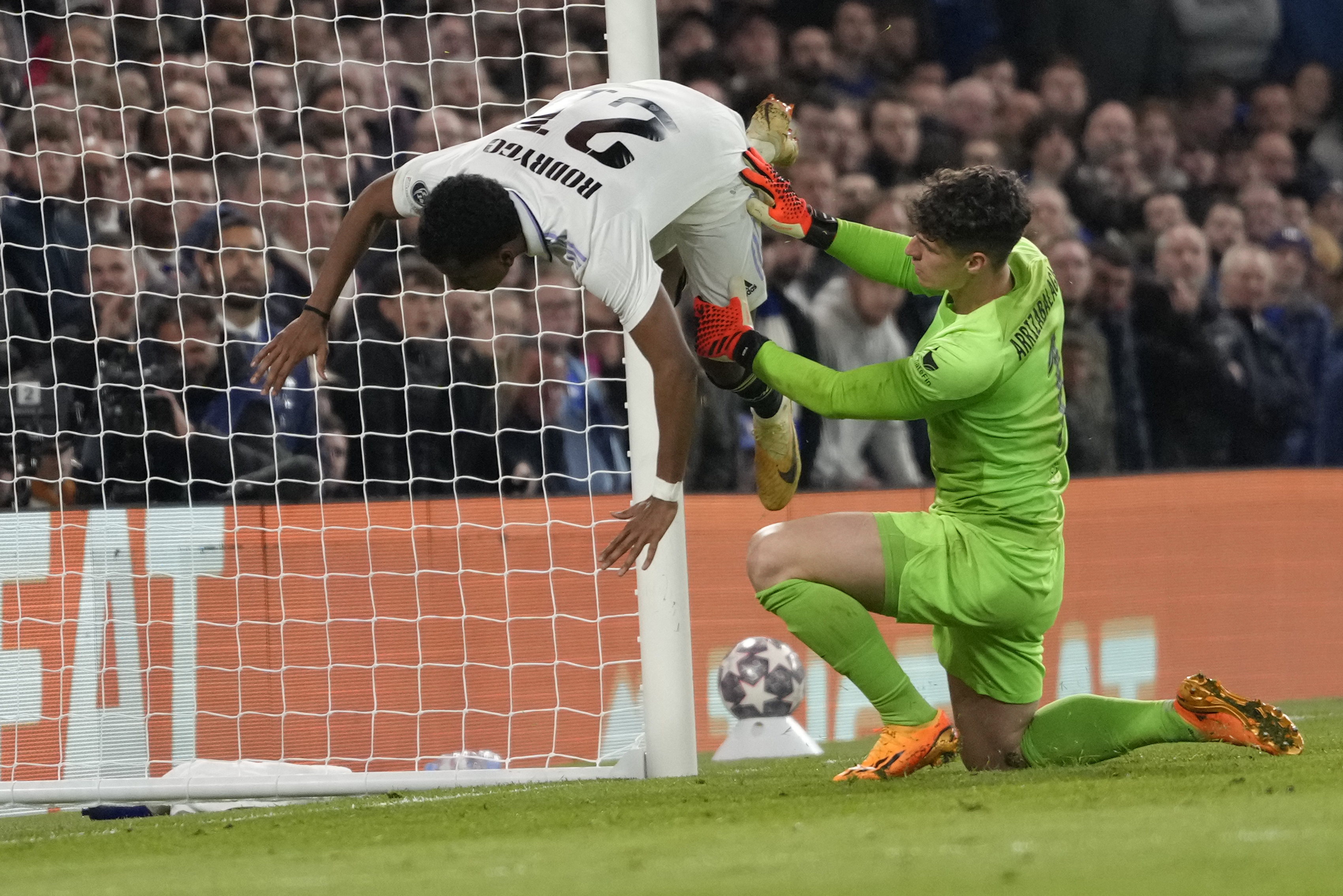 Real Madrid's Rodrygo, left, is fouled by Chelsea's goalkeeper Kepa Arrizabalaga after scoring his side's second goal during the Champions League quarterfinal second leg soccer match between Chelsea and Real Madrid at Stamford Bridge stadium in London, Tuesday, April 18, 2023. 