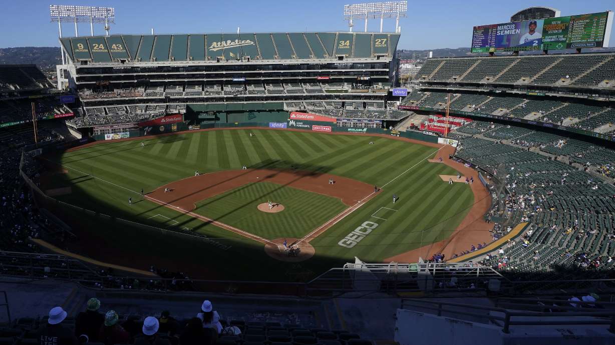 FILE - People watch a baseball game at Oakland Coliseum between the Oakland Athletics and the Texas Rangers in Oakland, Calif., July 23, 2022. The Athletics have signed a binding agreement to purchase land for a new retractable roof stadium in Las Vegas after being unable to build a new venue in the Bay Area. Team president Dave Kaval said Wednesday, April 19, 2023, that the team finalized the deal to buy the 49-acre site last week close to the Las Vegas Strip.