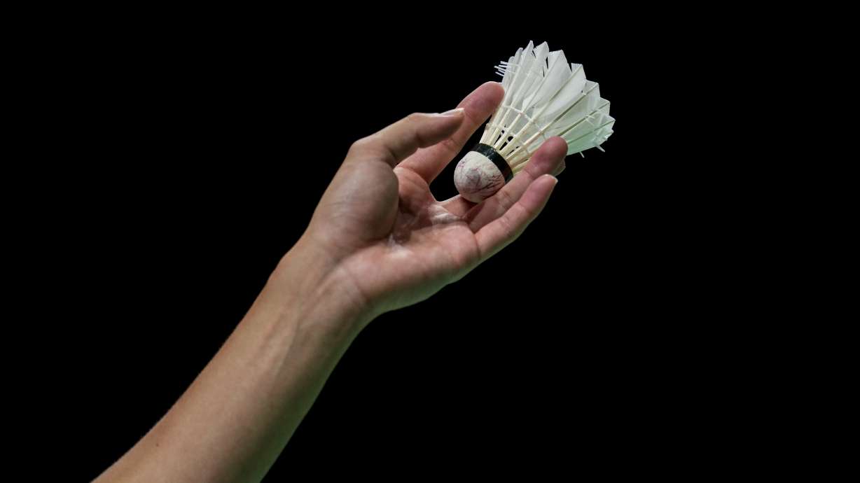 Japan's Kanta Tsuneyama prepares to serve against Russian Olympic Committee's Sergey Sirant during their men's badminton singles match at the BWF World Championships in Huelva, Spain, on Dec. 13, 2021. Badminton has upheld its ban on Russian and Belarusian players in international competitions on the eve of the start of Olympic qualifying. The Badminton World Federation cites security concerns and says it needs “more clarity” on proposals from the International Olympic.