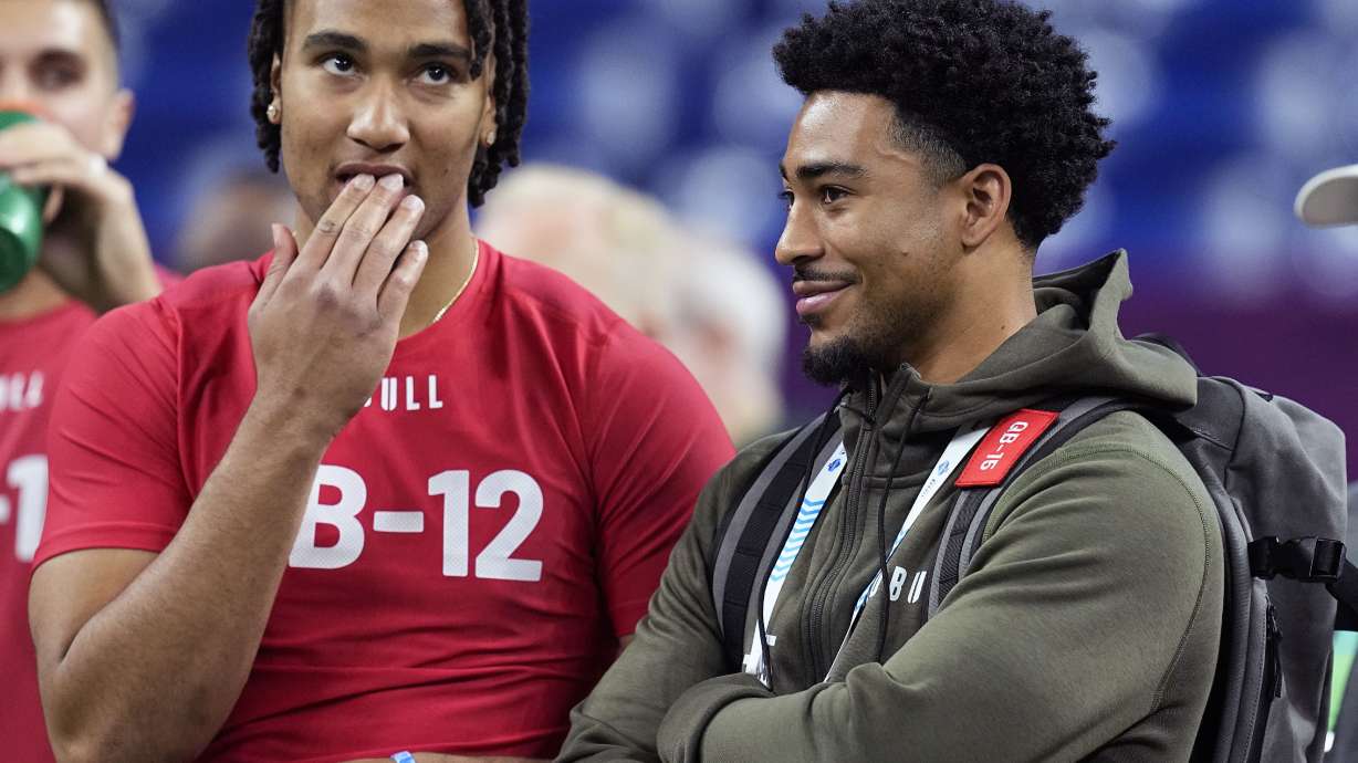 FILE - Ohio State quarterback CJ Stroud, left, talks to Alabama quarterback Bryce Young at the NFL football scouting combine in Indianapolis, Saturday, March 4, 2023. The Carolina Panthers have been on the clock since making a blockbuster trade last month to acquire the No. 1 overall pick in the NFL draft and get their choice of potential franchise quarterbacks. There is still no general consensus on which QB will go first. Stroud or Young?