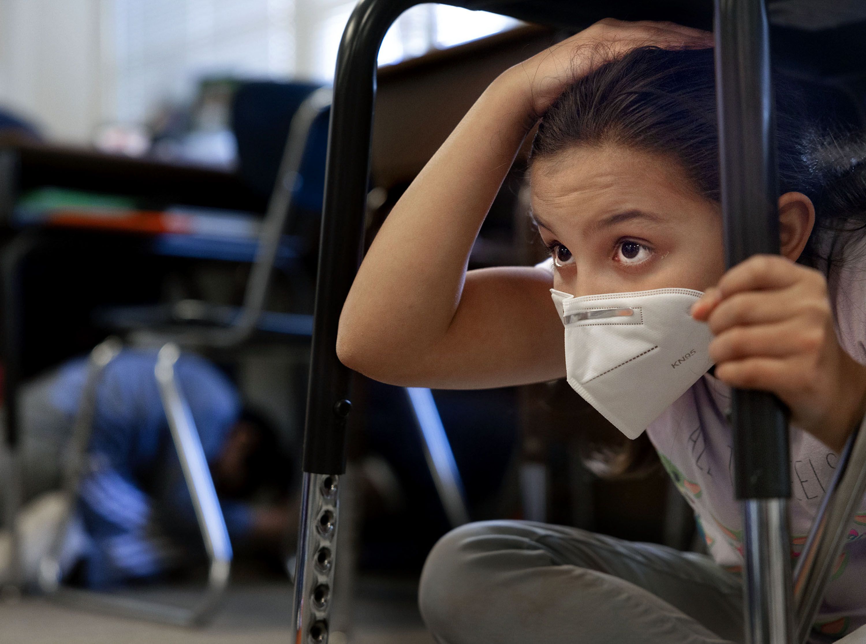 Third grader Stormie Ortiz participates in the statewide Utah ShakeOut at Lincoln Elementary School in Salt Lake City on Thursday. The earthquake preparedness drill encourages Utahns to practice what to do in the event of a large earthquake.