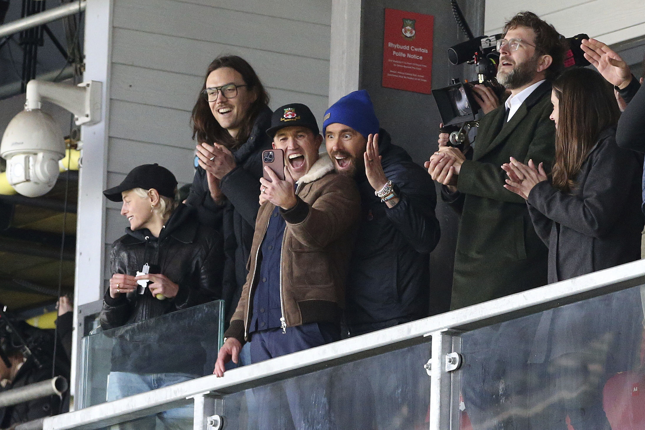 FILE - Wrexham owners Ryan Reynolds, center right, and Rob McElhenney, center left, react during the National League match between Wrexham and Notts County at the Racecourse Ground, Wrexham, Wales, Monday April 10, 2023. It's hard to imagine that even A-list owners Ryan Reynolds and Rob McElhenney anticipated the unscripted drama created by this unlikely union between Tinseltown and Wrexham, a former mining town in Wales. 